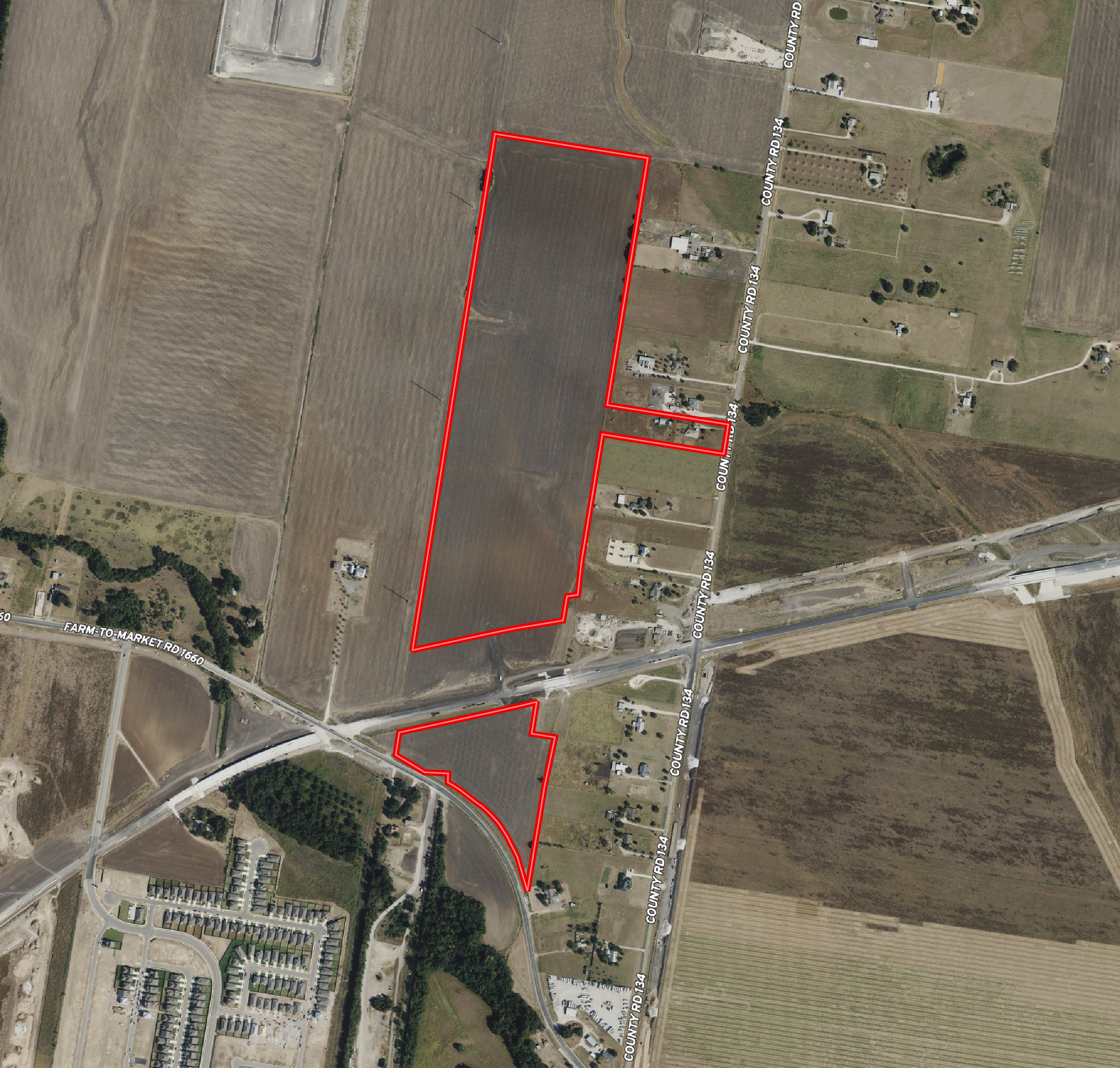 Aerial view of farmland and residential area, with a red outline marking a specific plot of land next to County Road 134.