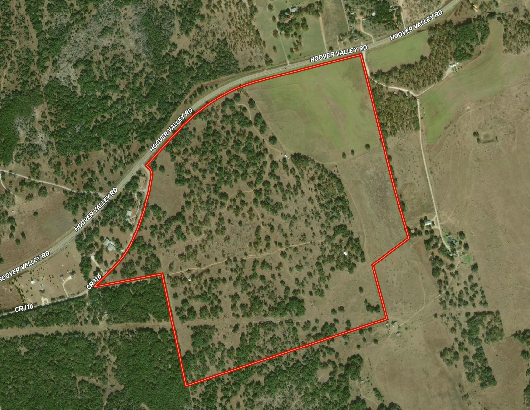 Aerial view of a piece of land outlined in red, showing wooded areas and open fields. Roads named Hoover Valley Road and CR 116 are visible, with some residential properties in the vicinity.
