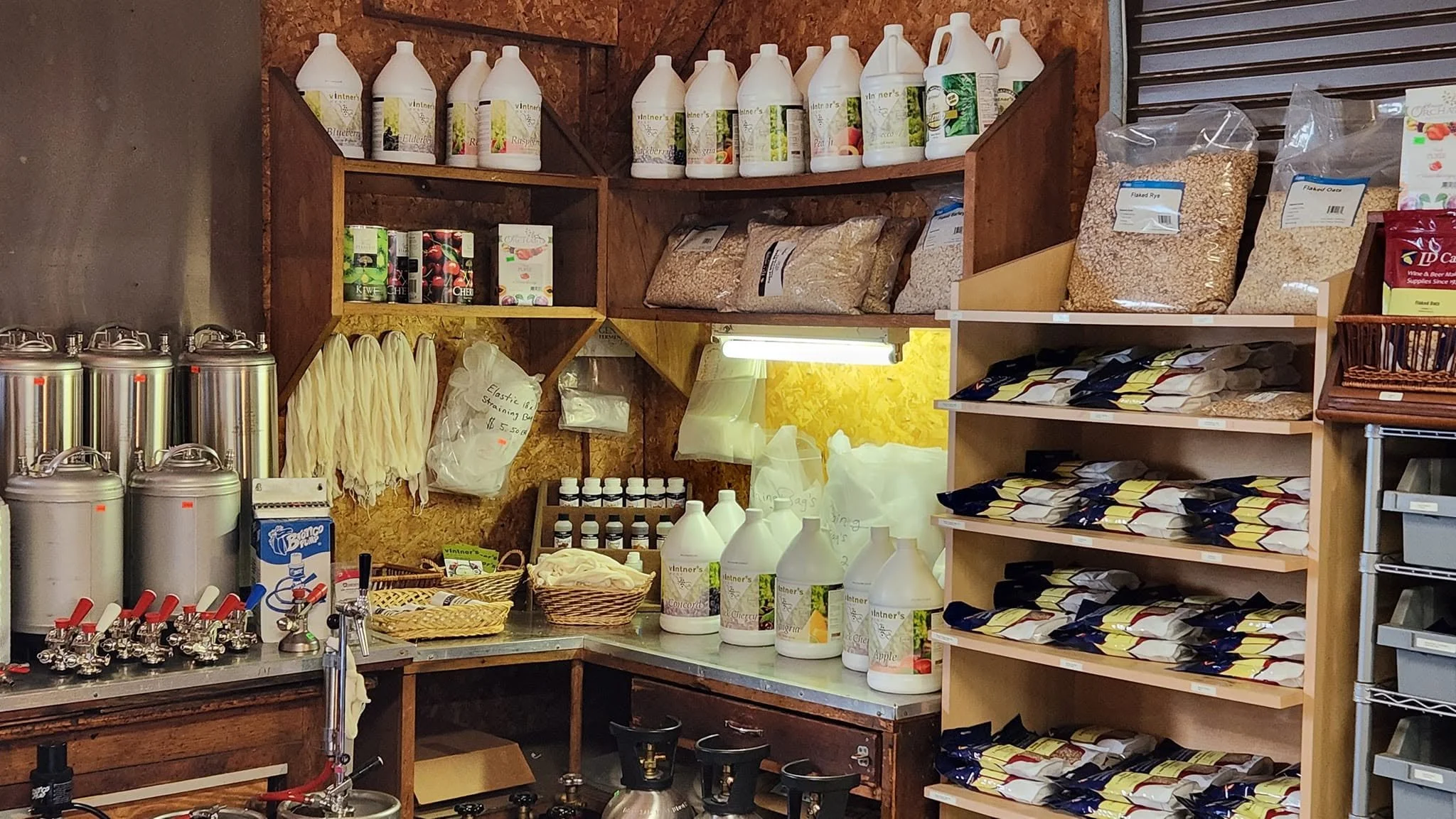 Stainless tanks, buckets, and winemaking supplies in the shop