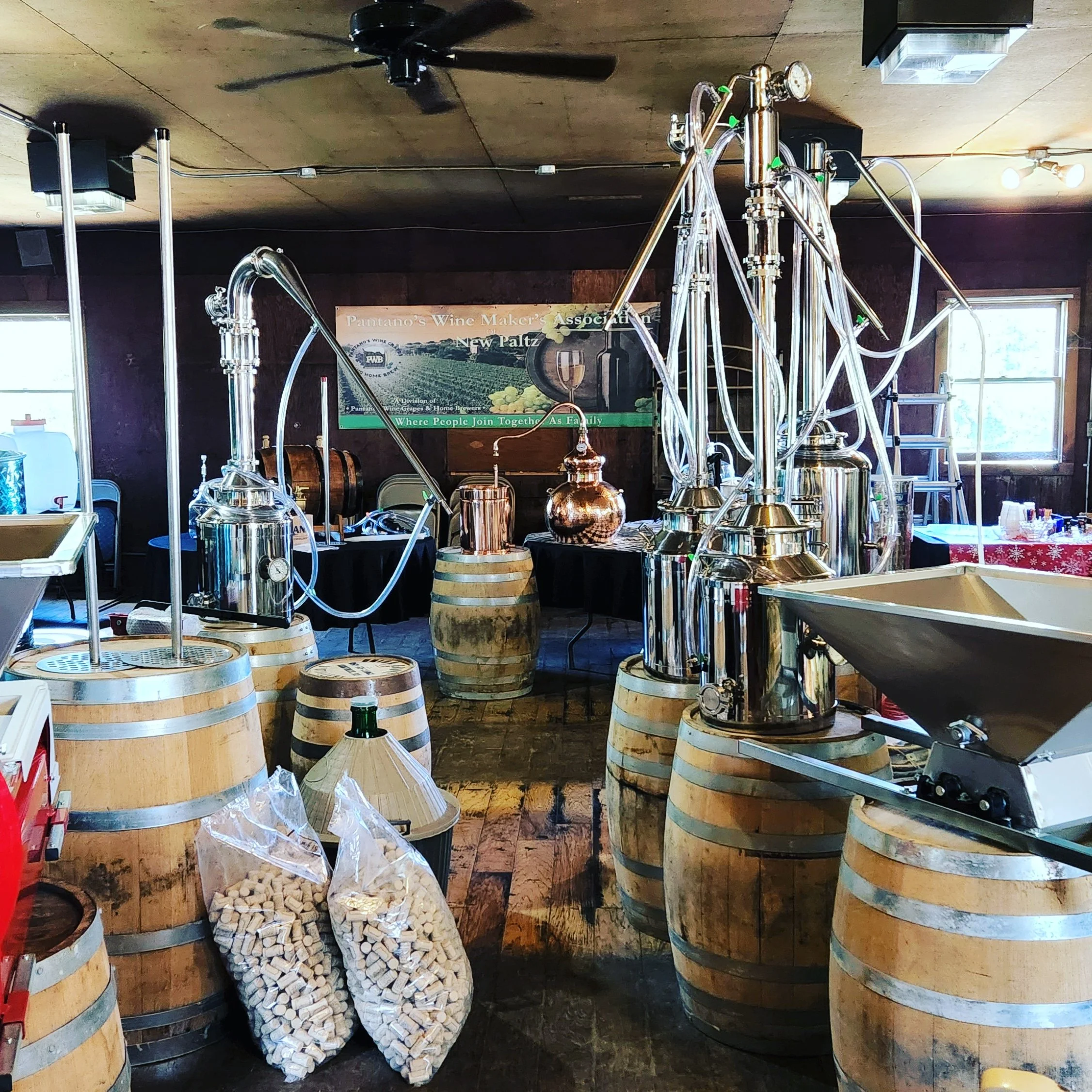 Copper and stainless distilling equipment with barrels inside Pantano's