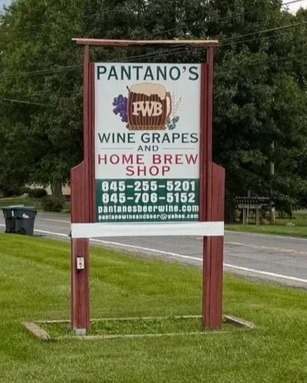 Sign for Pantano's Wine Grapes and Home Brew Shop with contact information.