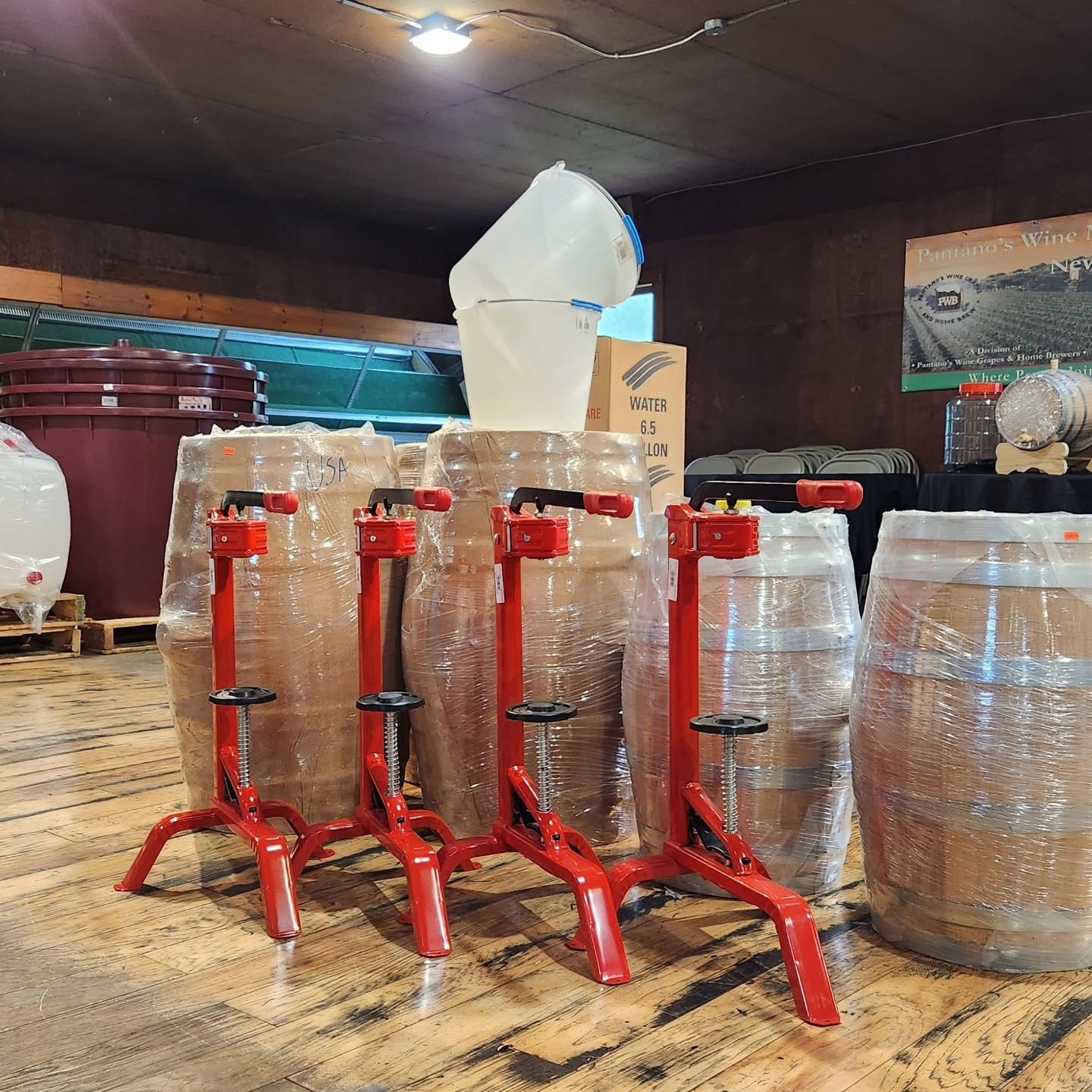 Red fruit presses and clear fermenters for winemaking at Pantano's