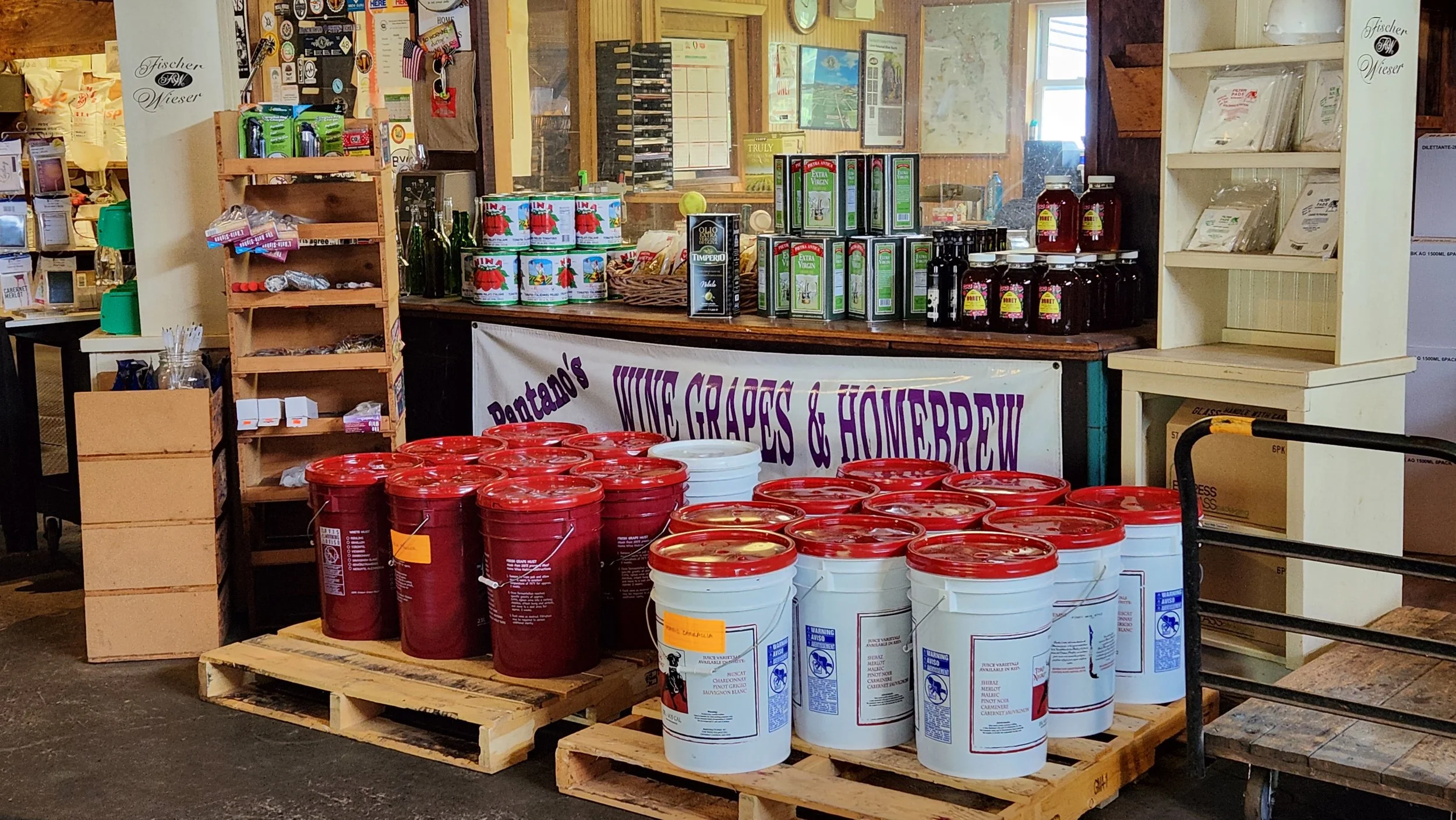 Red wine juice pails and buckets stacked inside Pantano's