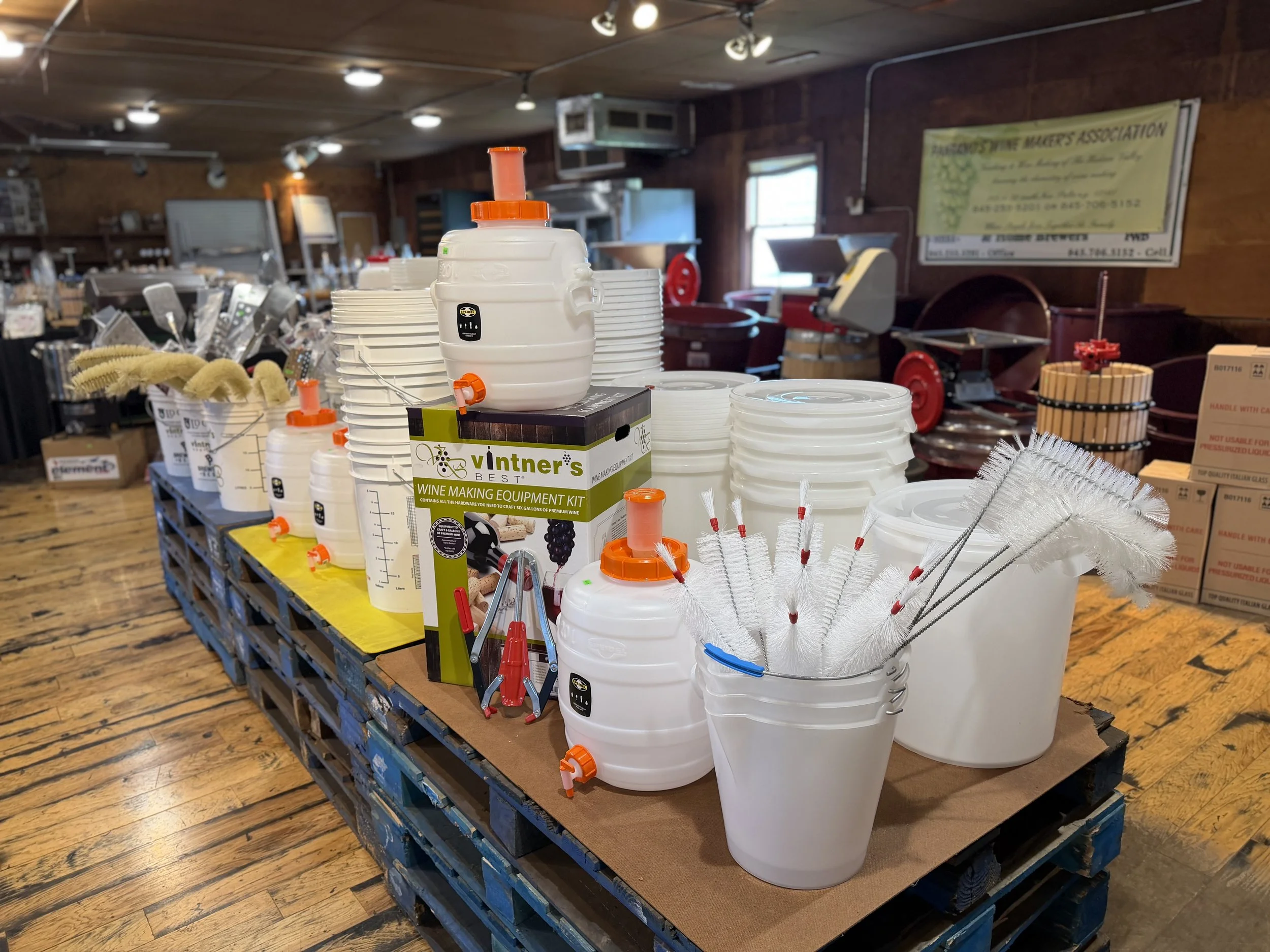 Wine making equipment kit, fermenters, buckets, and cleaning brushes at Pantano's