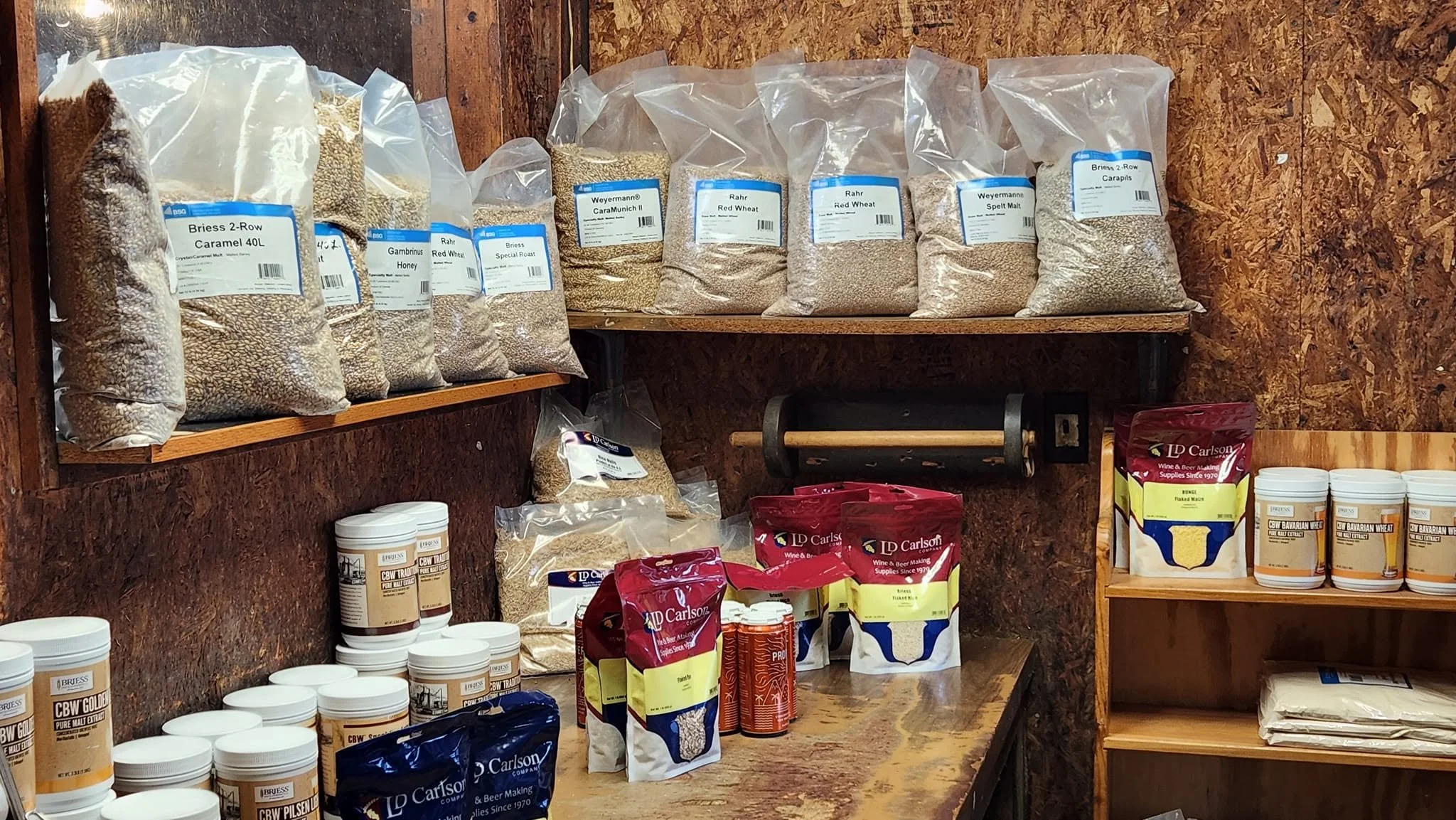 Bags of brewing grains and homebrew ingredients on Pantano's shelves