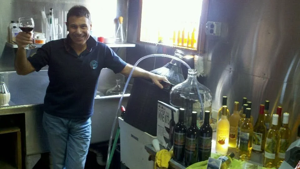 Jerry Pantano with bottles and winemaking equipment in the shop