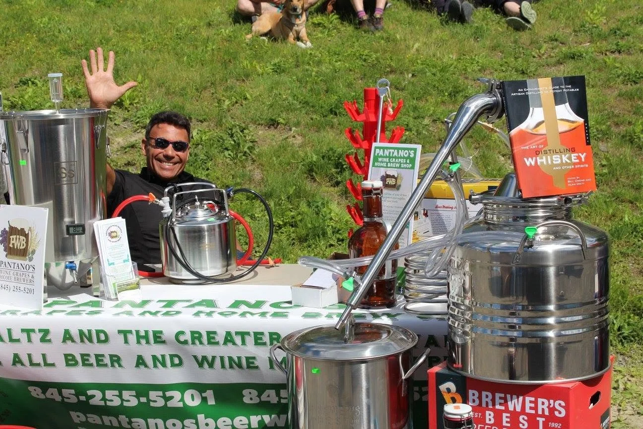 Jerry Pantano with distilling equipment outside Pantano's Wine Grapes