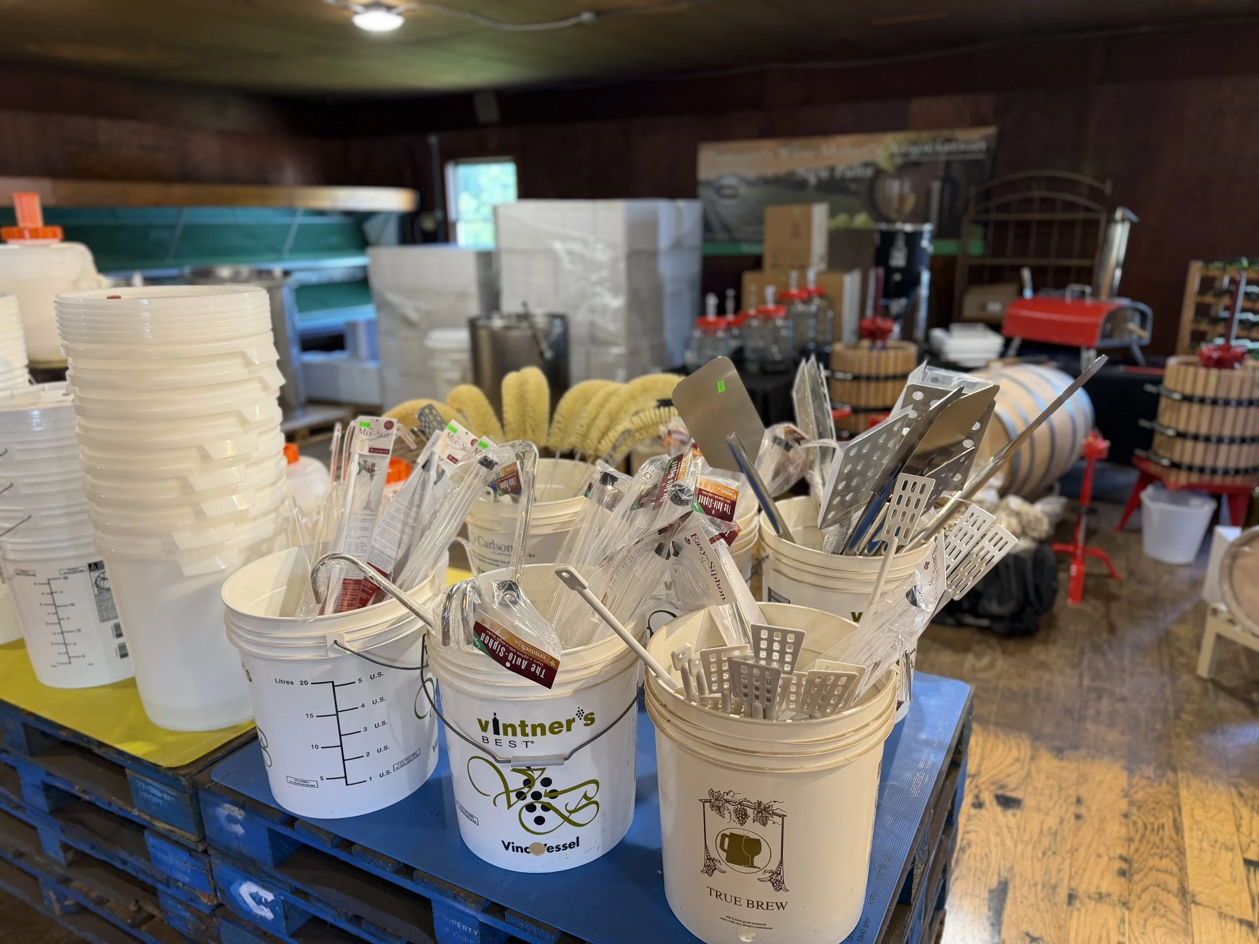 Buckets, brushes, and fermentation equipment displayed at Pantano's