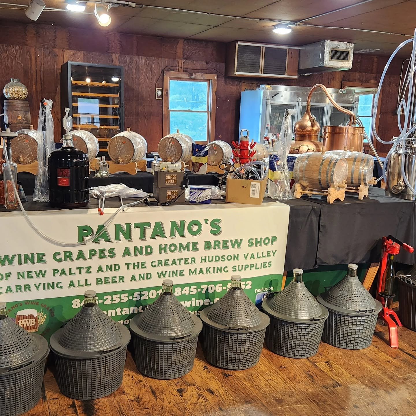 Distilling equipment display with Pantano's Wine Grapes sign