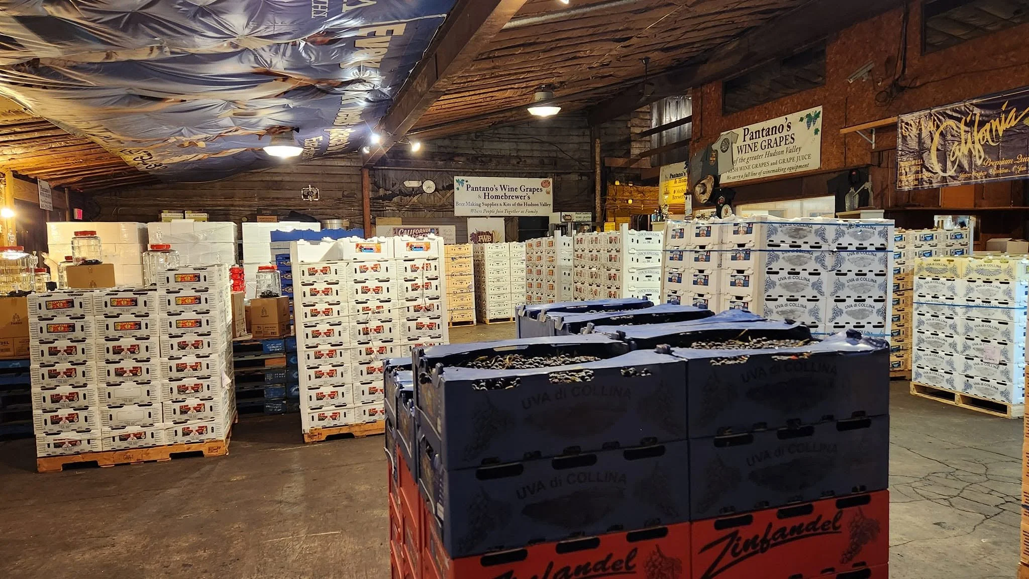 Warehouse stacks of wine grape crates and seasonal supplies
