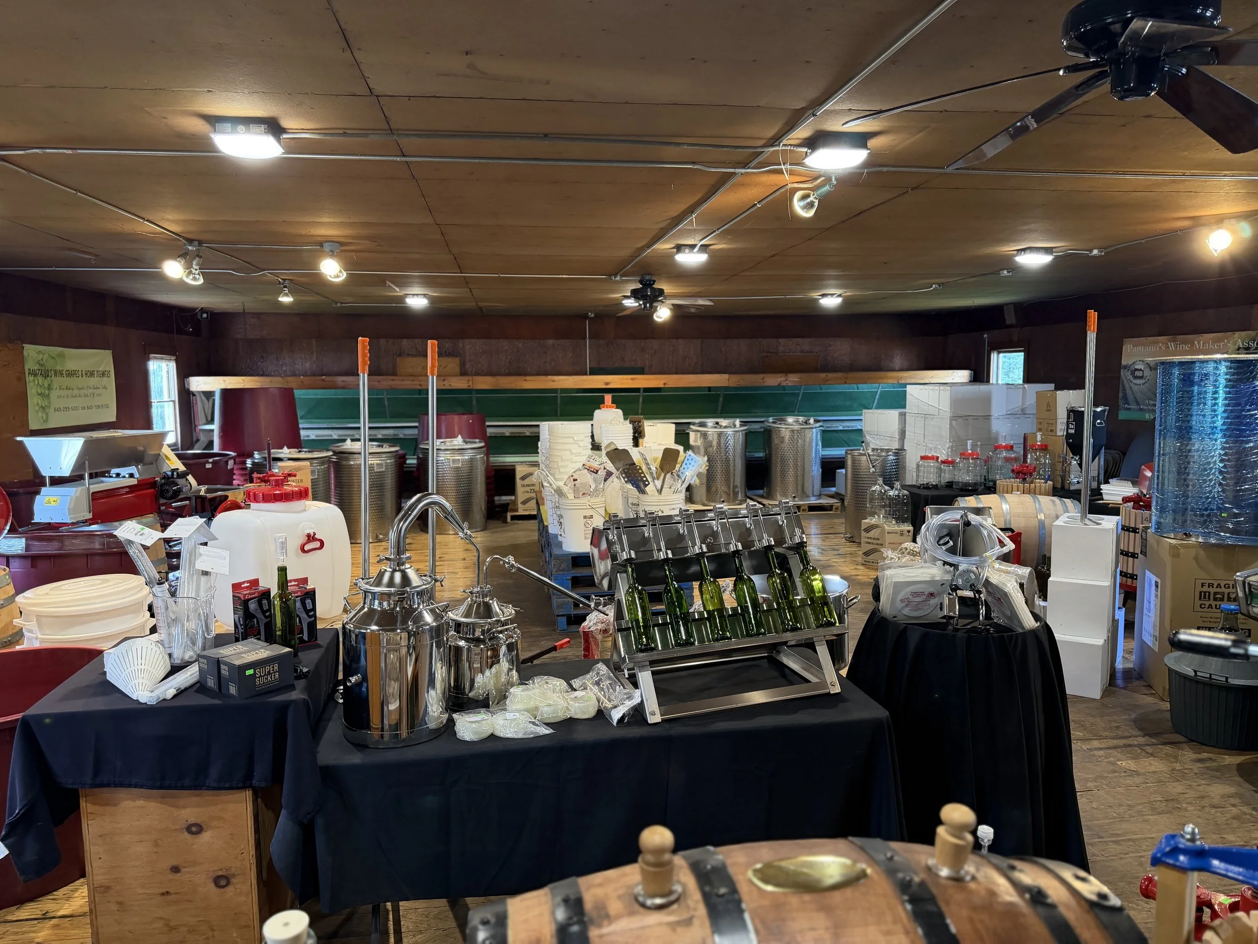 Shop tables filled with distilling and winemaking equipment