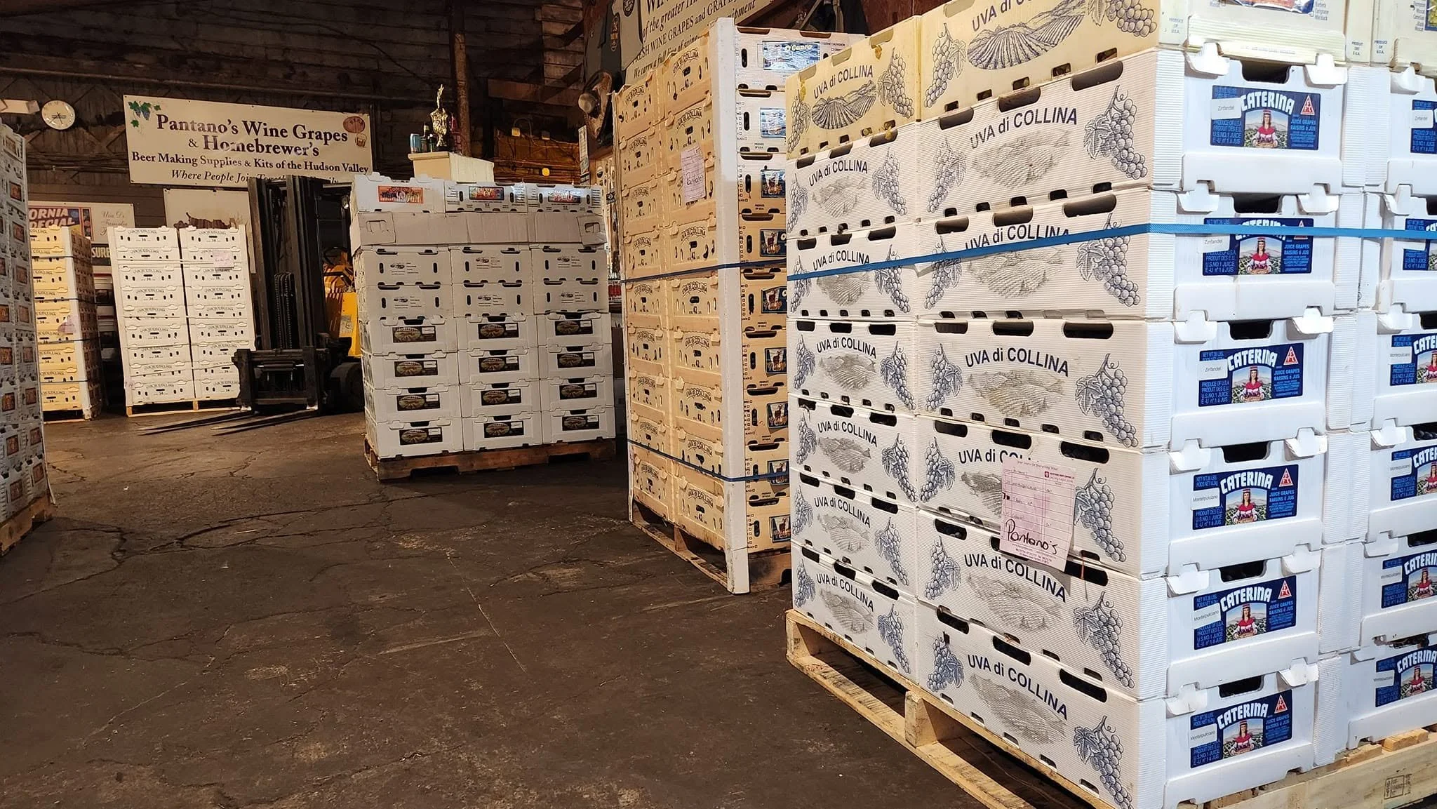 Boxed wine juice pails and grain bags in the Pantano's warehouse area