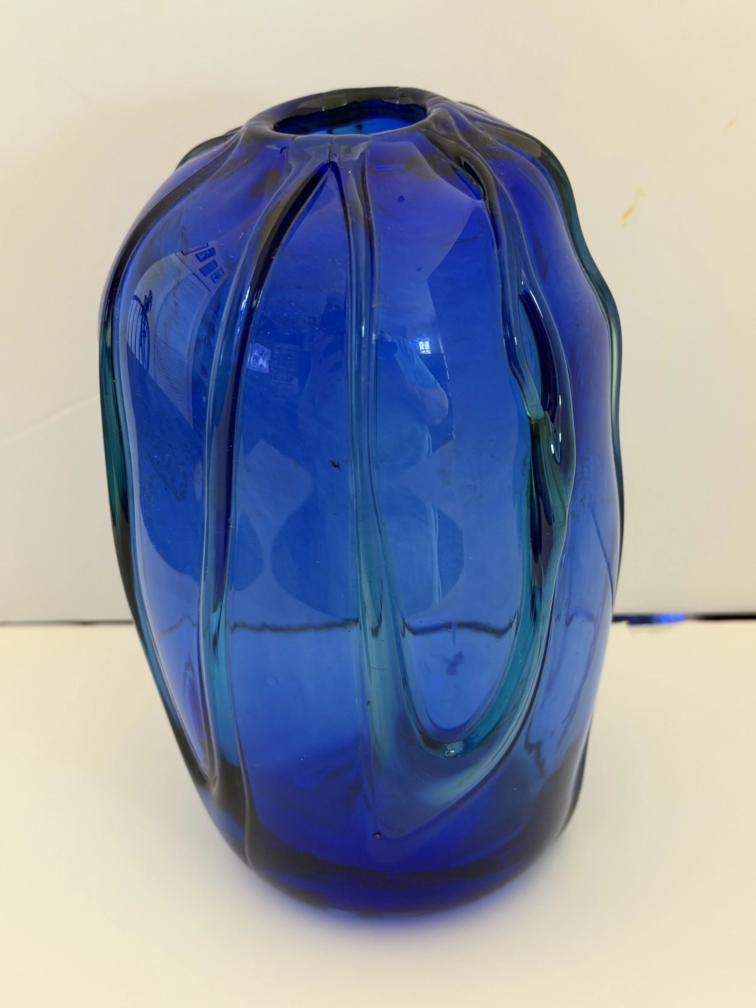 Handblown glass vase: Asymmetrical cobalt blue with green vines.