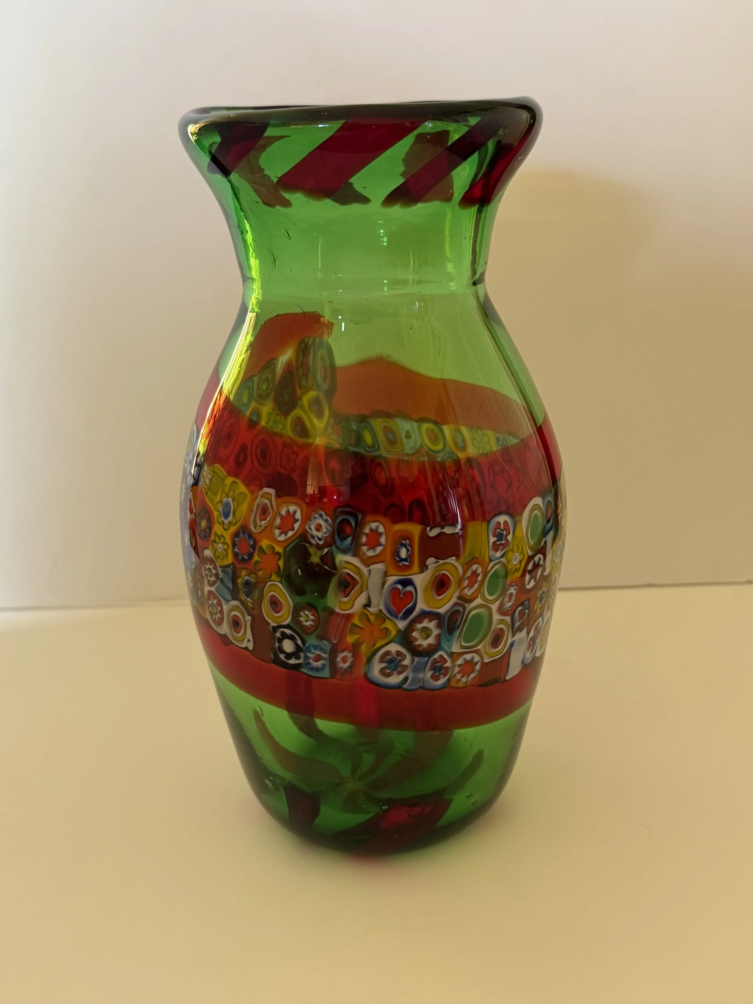 Handblown glass vase: Transparent green with millefiori midsection bordered by transparent red.