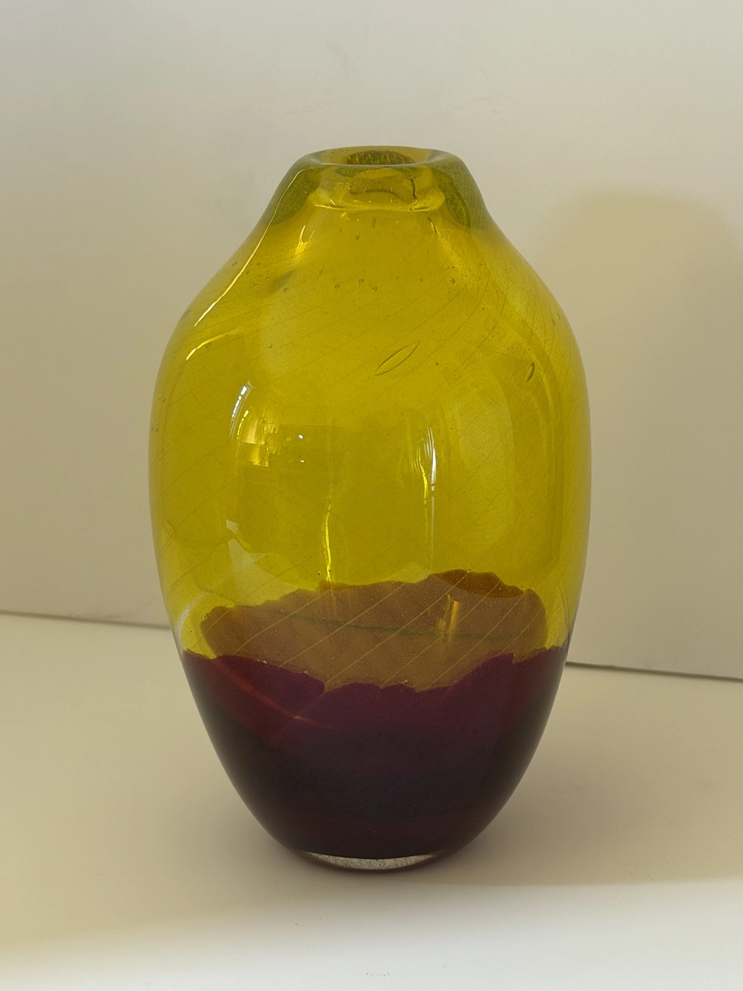 Handblown glass vase: Transparent yellow with deep red base.