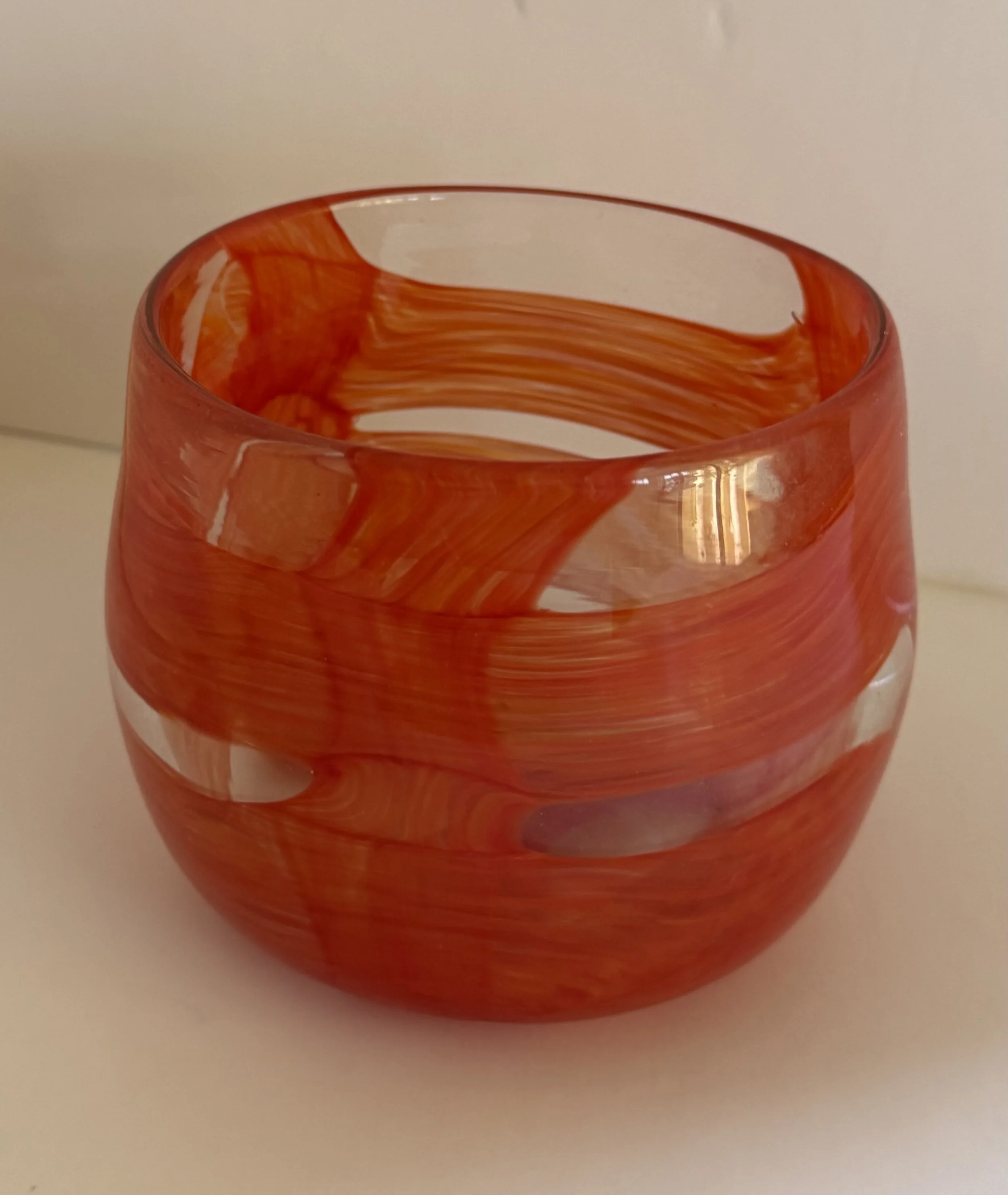 Handblown glass bowl: Small, clear round bowl with large orange bands.