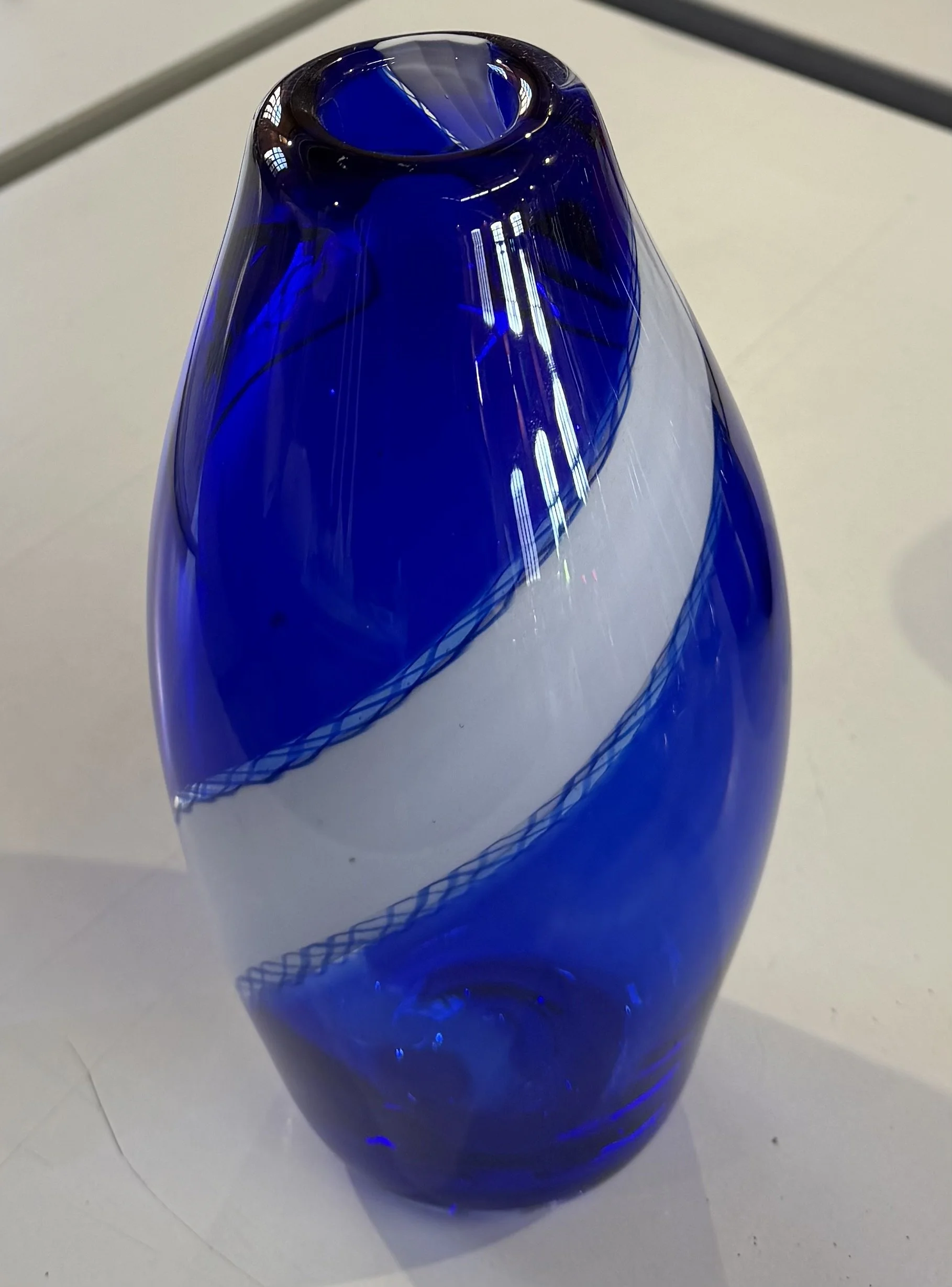 Handblown glass vase: Transparent blue with white band.