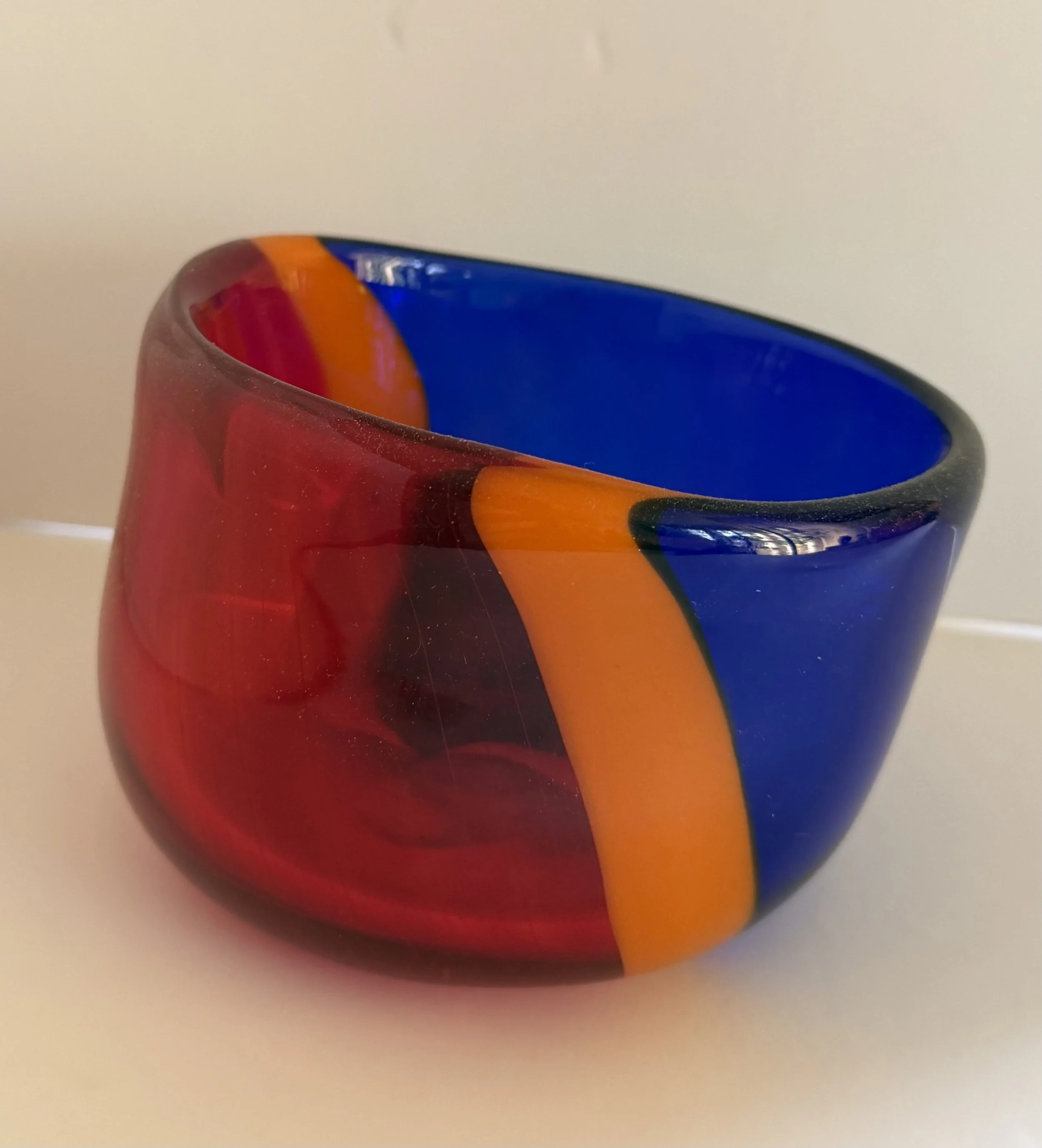 Handblown glass bowl: Asymmetrical bowl with transparent red and blue plus orange band.