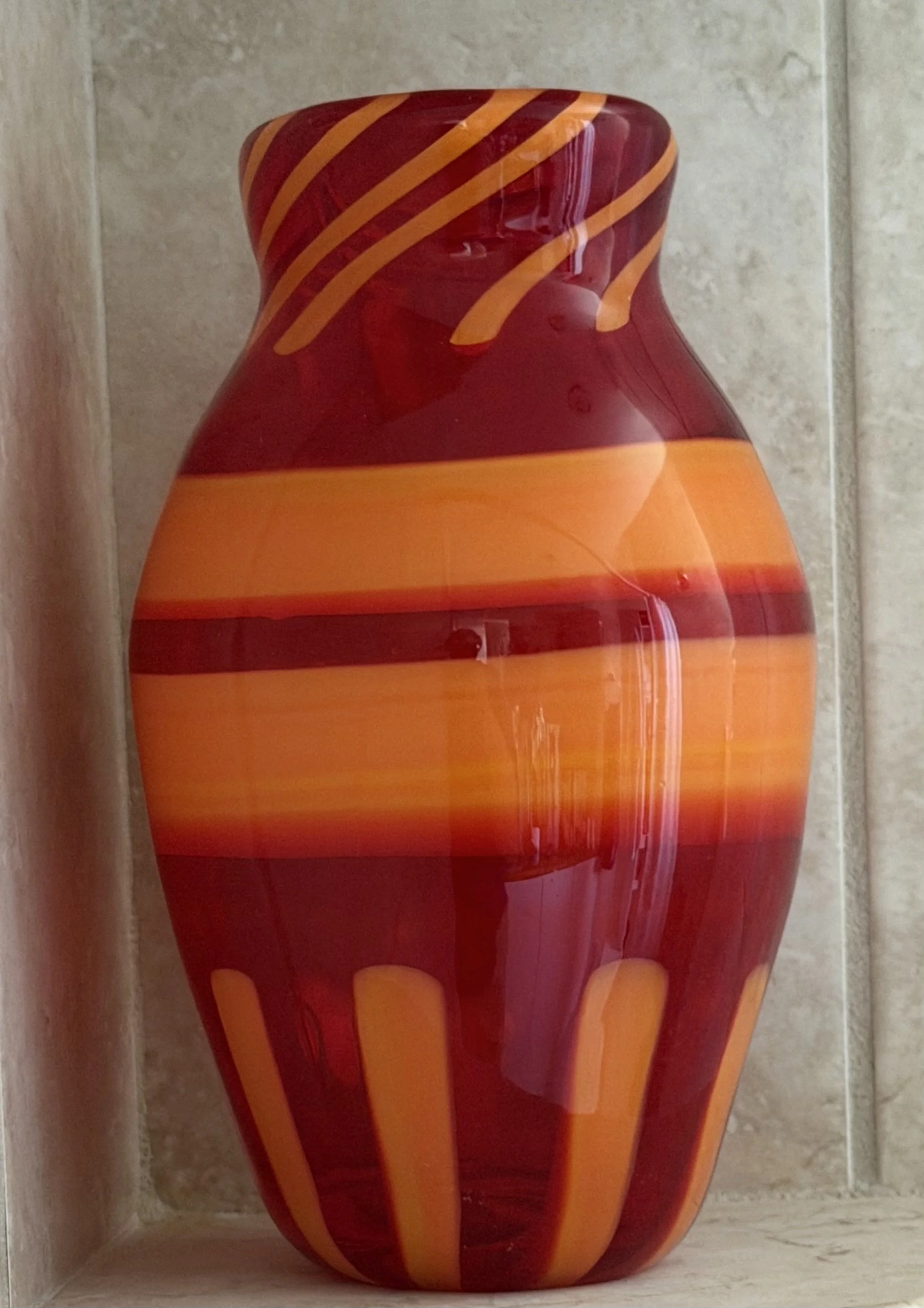 Handblown glass vase: Red with large orange stripes.