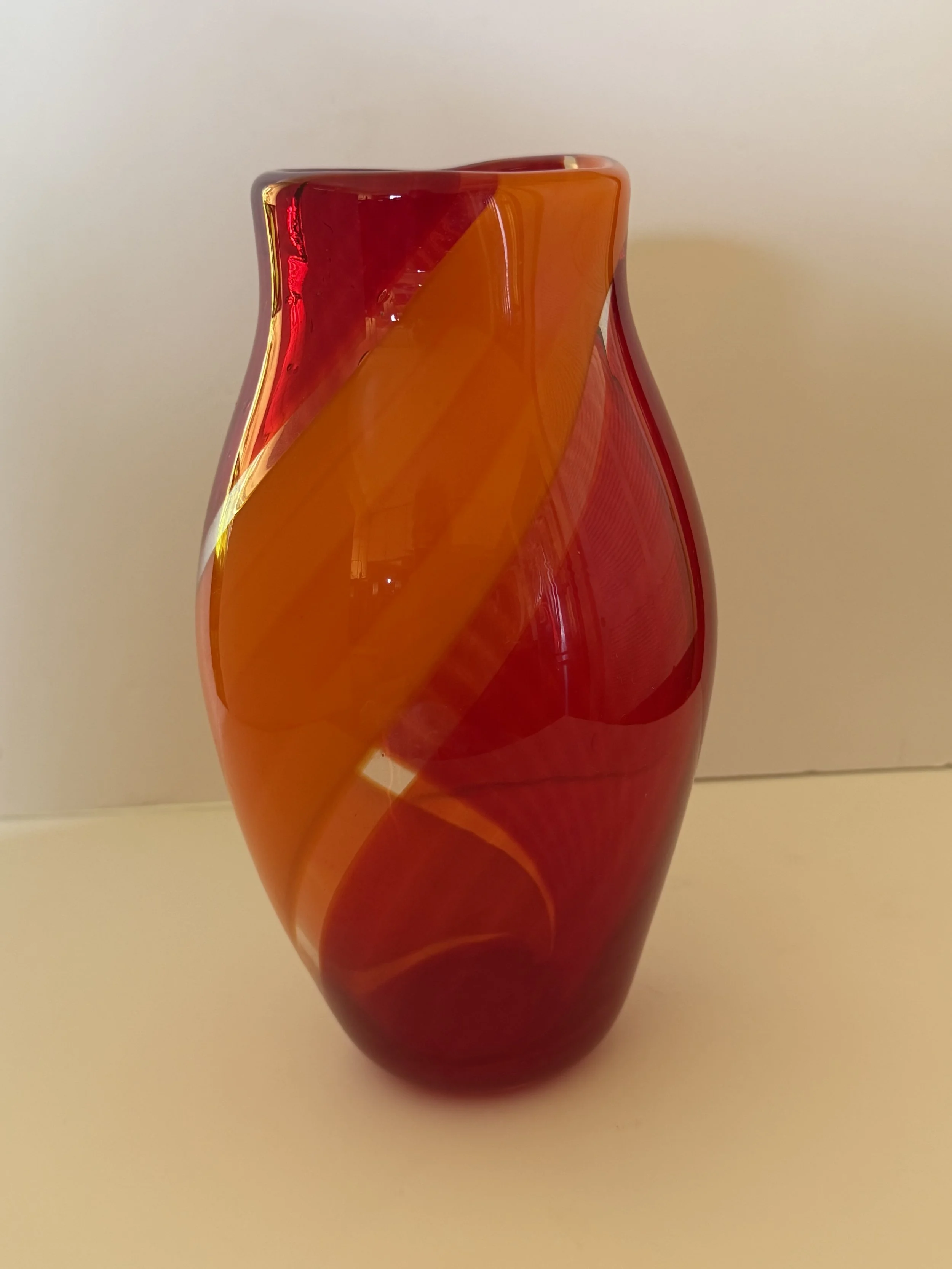 Handblown glass vase, Transparent red with opaque sweeping orange swish.