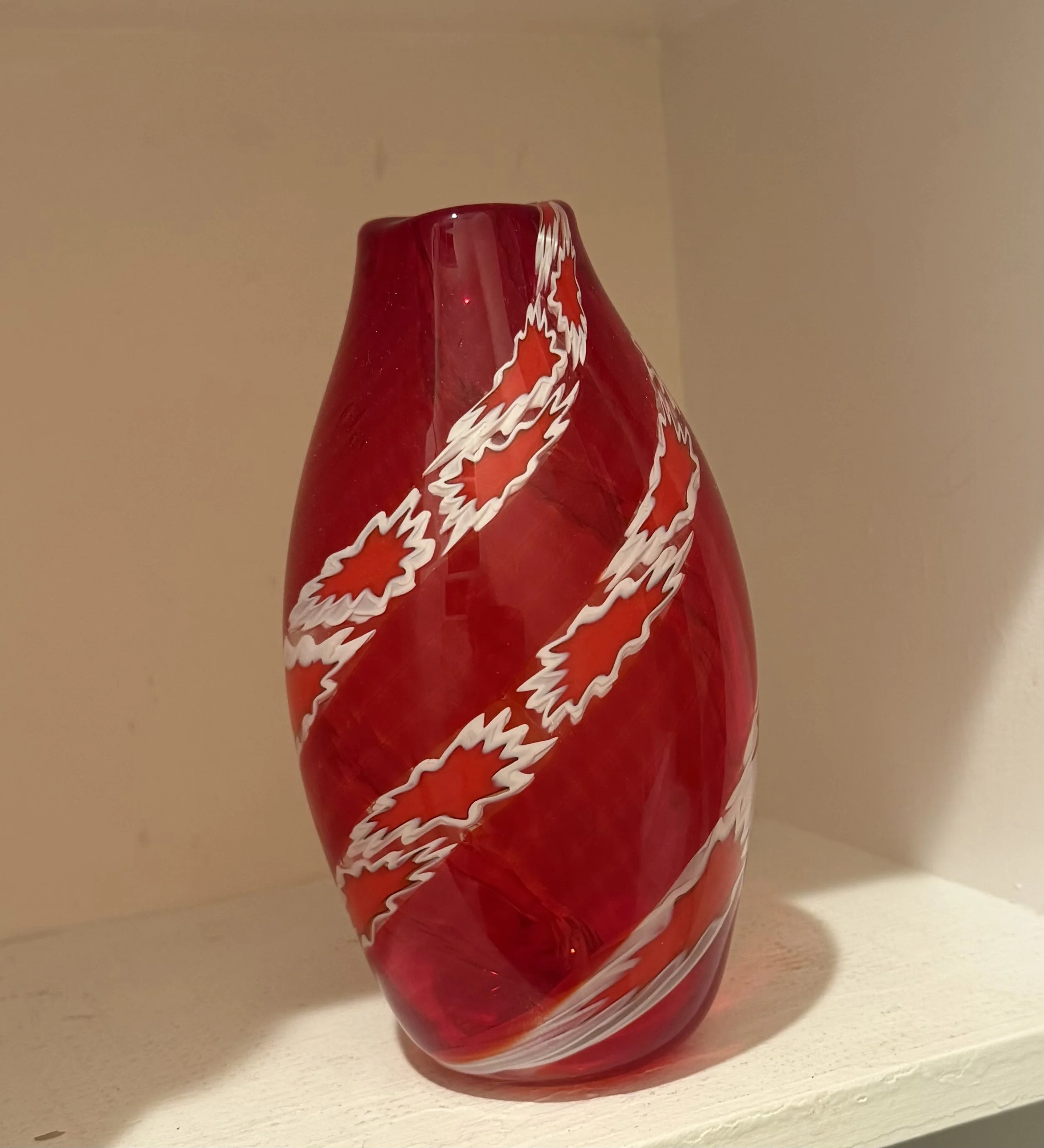 Handblown glass vase: Transparent red with jagged red-and-white cane bits.