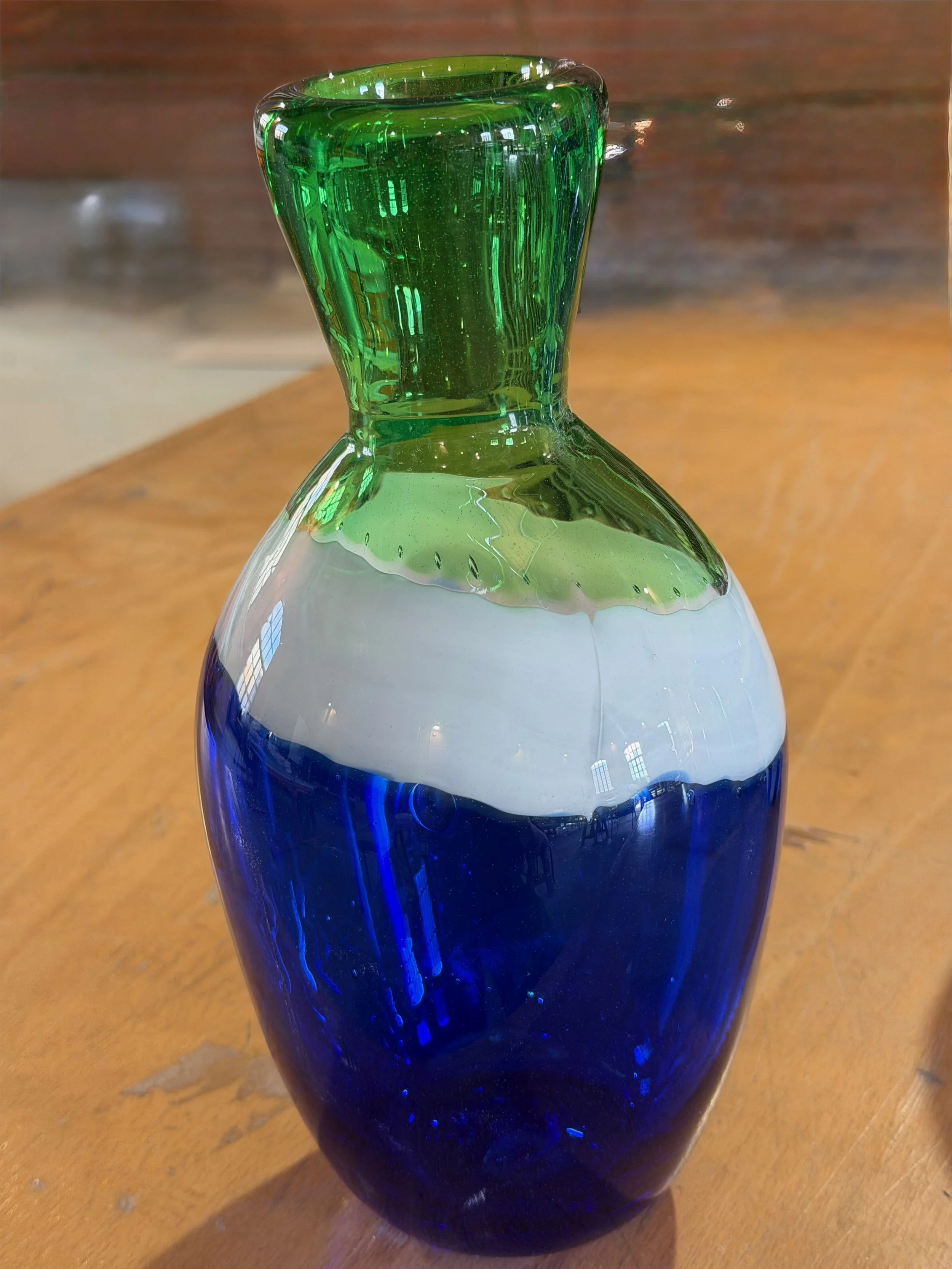 Handblown glass vase: Blue, white and green banded bottle-shaped vase.