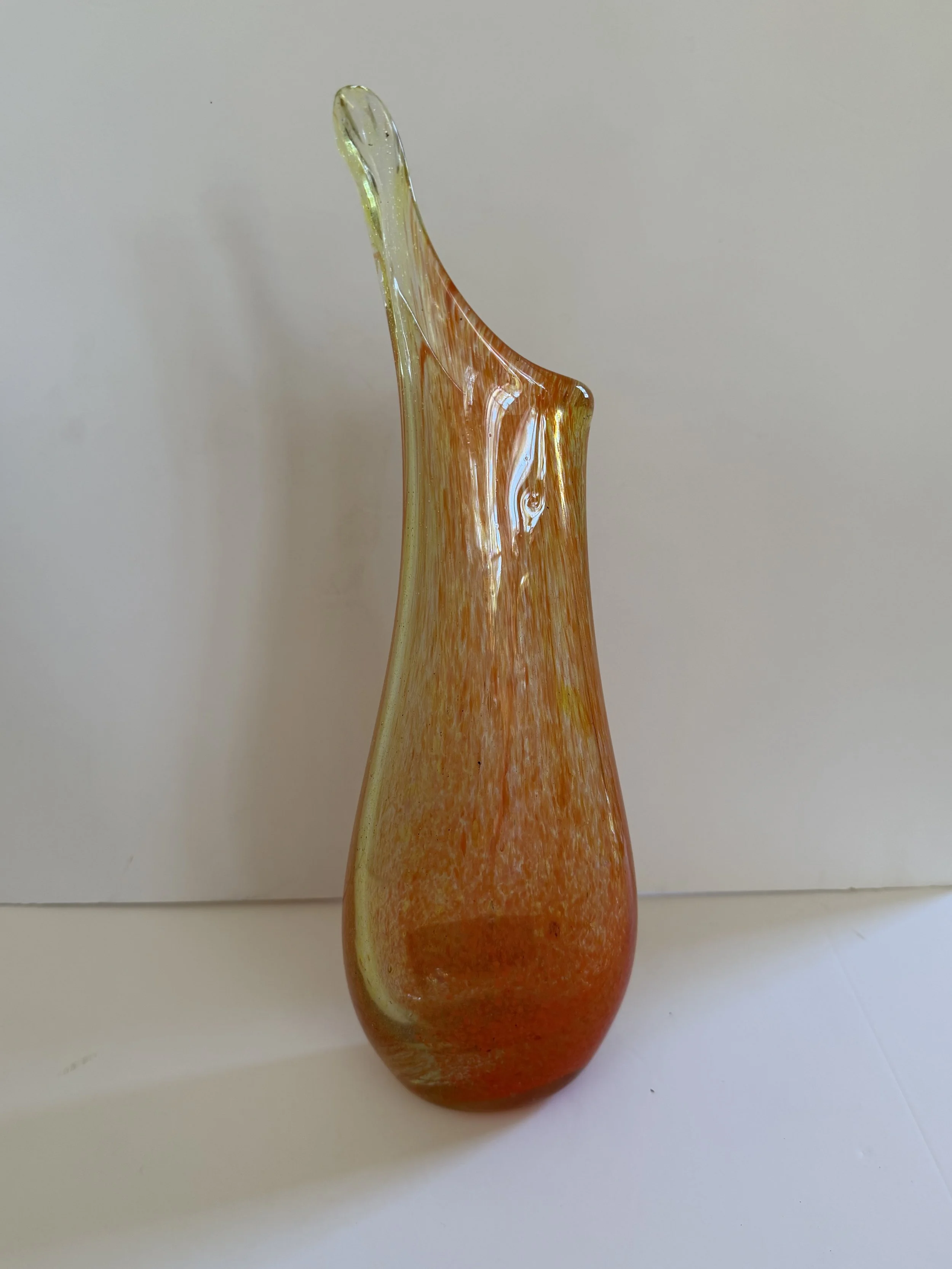 Handblown glass vase: Tall, flat orange and spiky.