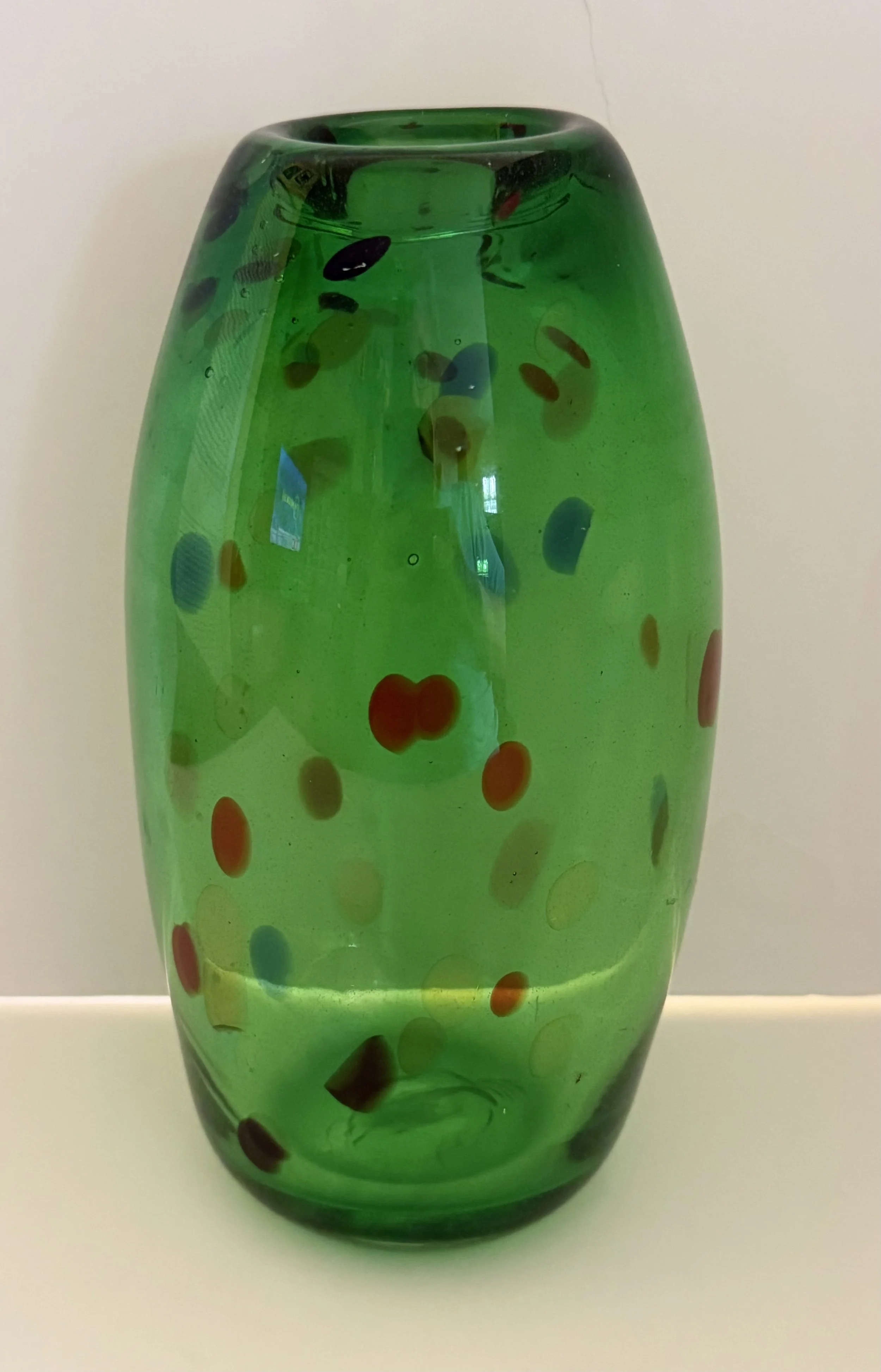 Handblown glass vase: Transparent green with multicolored speckles.