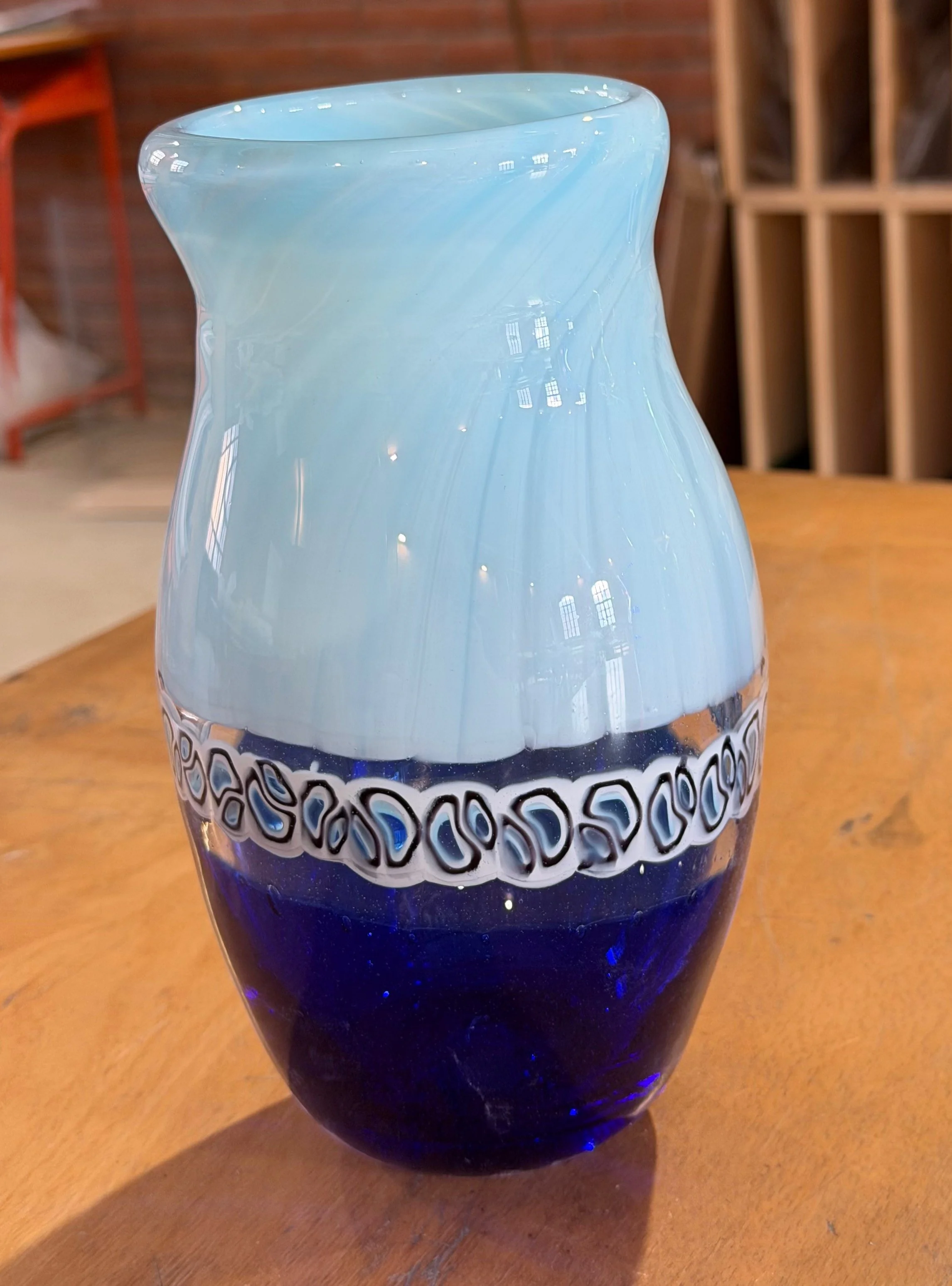 Handblown glass vase: Transparent cobalt and milky blue with a cane-chip belt.