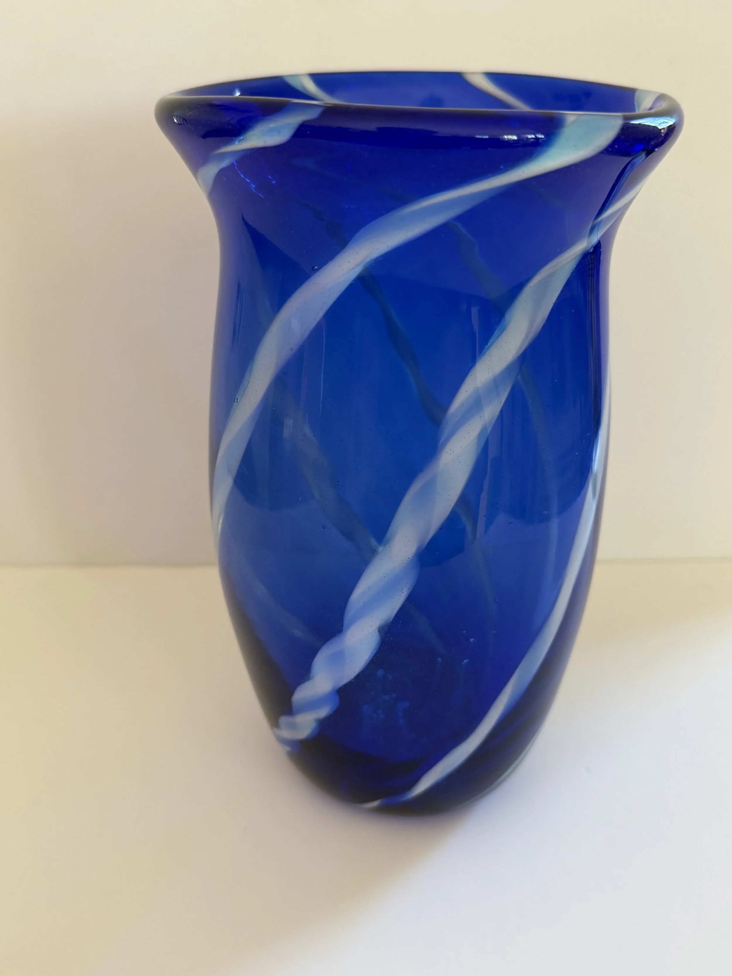 Handblown glass vase: Large-mouthed transparent blue with handmade blue and white cane stripes.