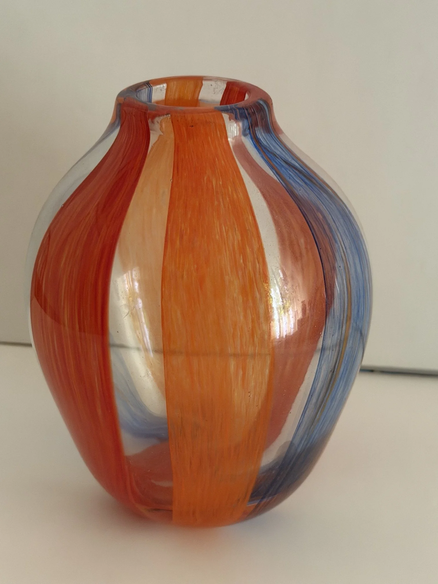 Handblown glass vase: Small, clear ovoid with blue, red and orange bands.