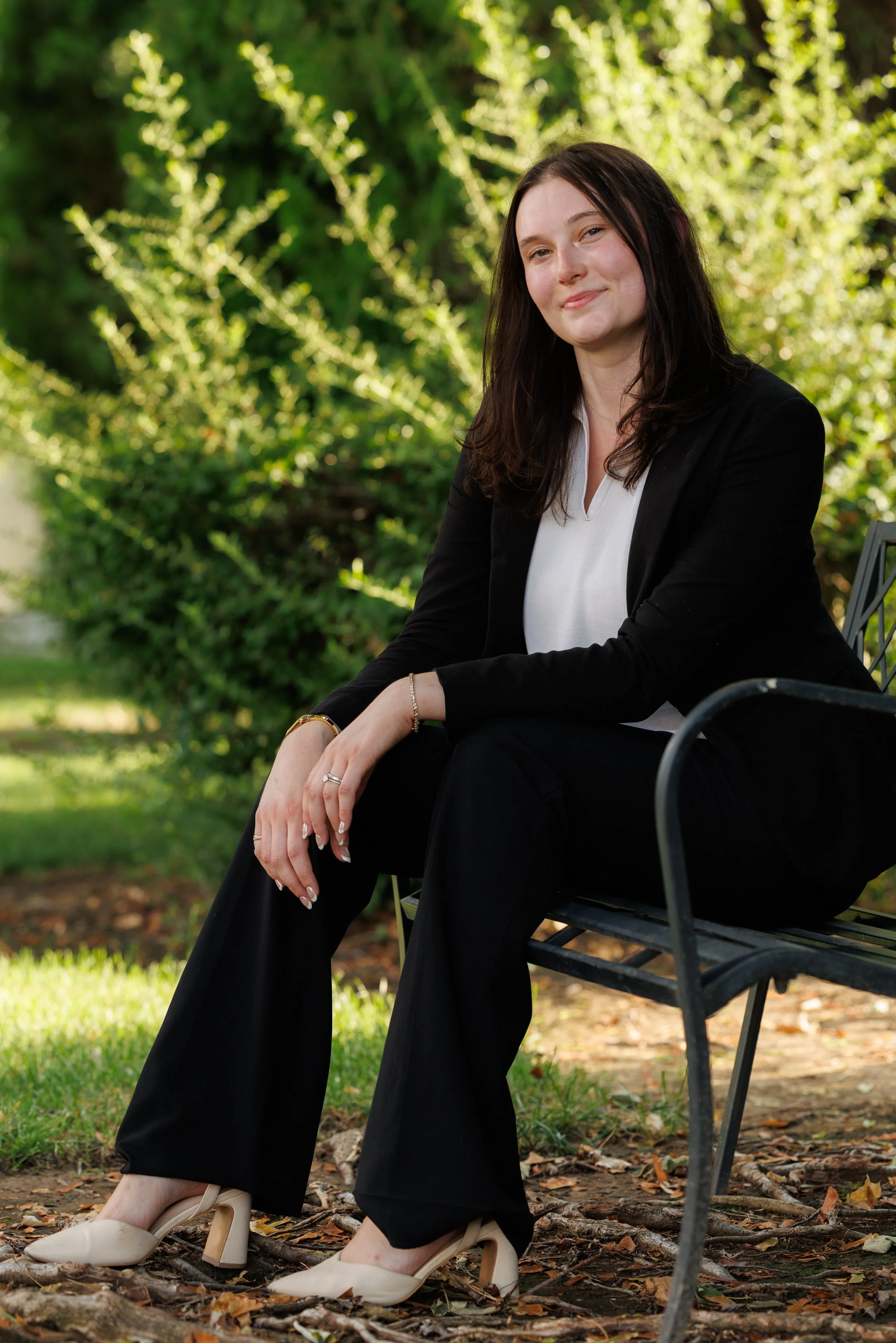 Full-length portrait of Audrie Floyd seated on a bench