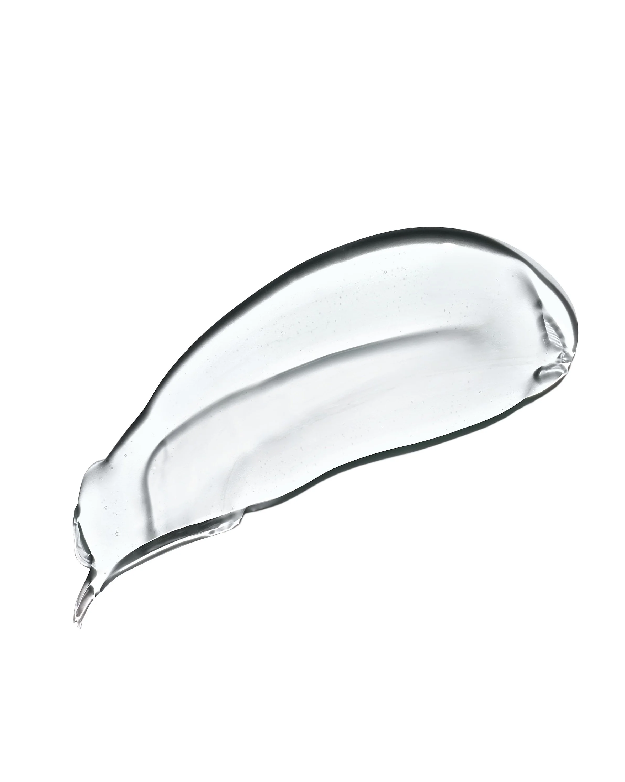 Close-up of a curved, transparent glass object with water droplets on its surface, set against a plain white background.