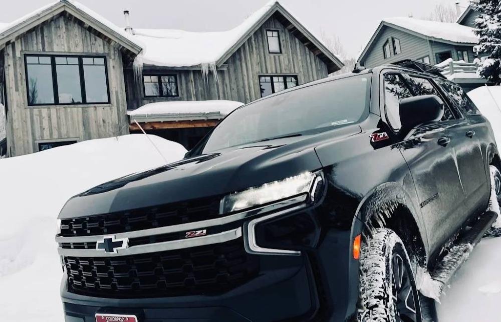 Black Chevrolet Suburban Z71 parked in front of a house in Telluride on a snowy morning.