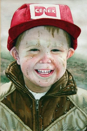A young boy smiling, wearing a red cap with a white and red logo, and a brown jacket.