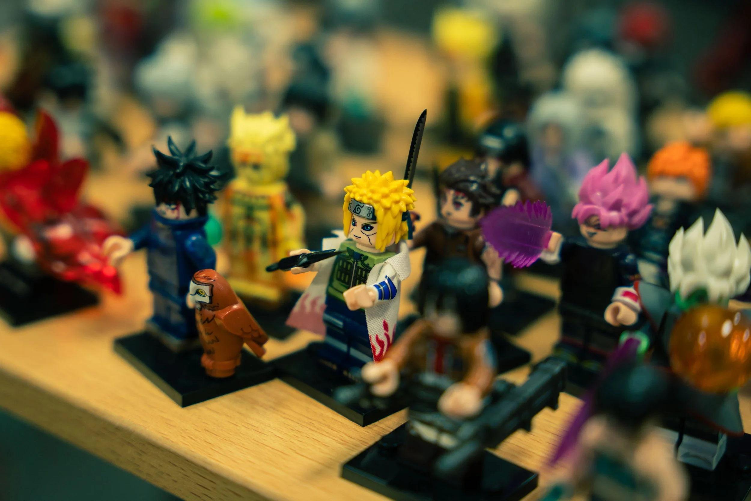A collection of colorful LEGO minifigures arranged on a display shelf.