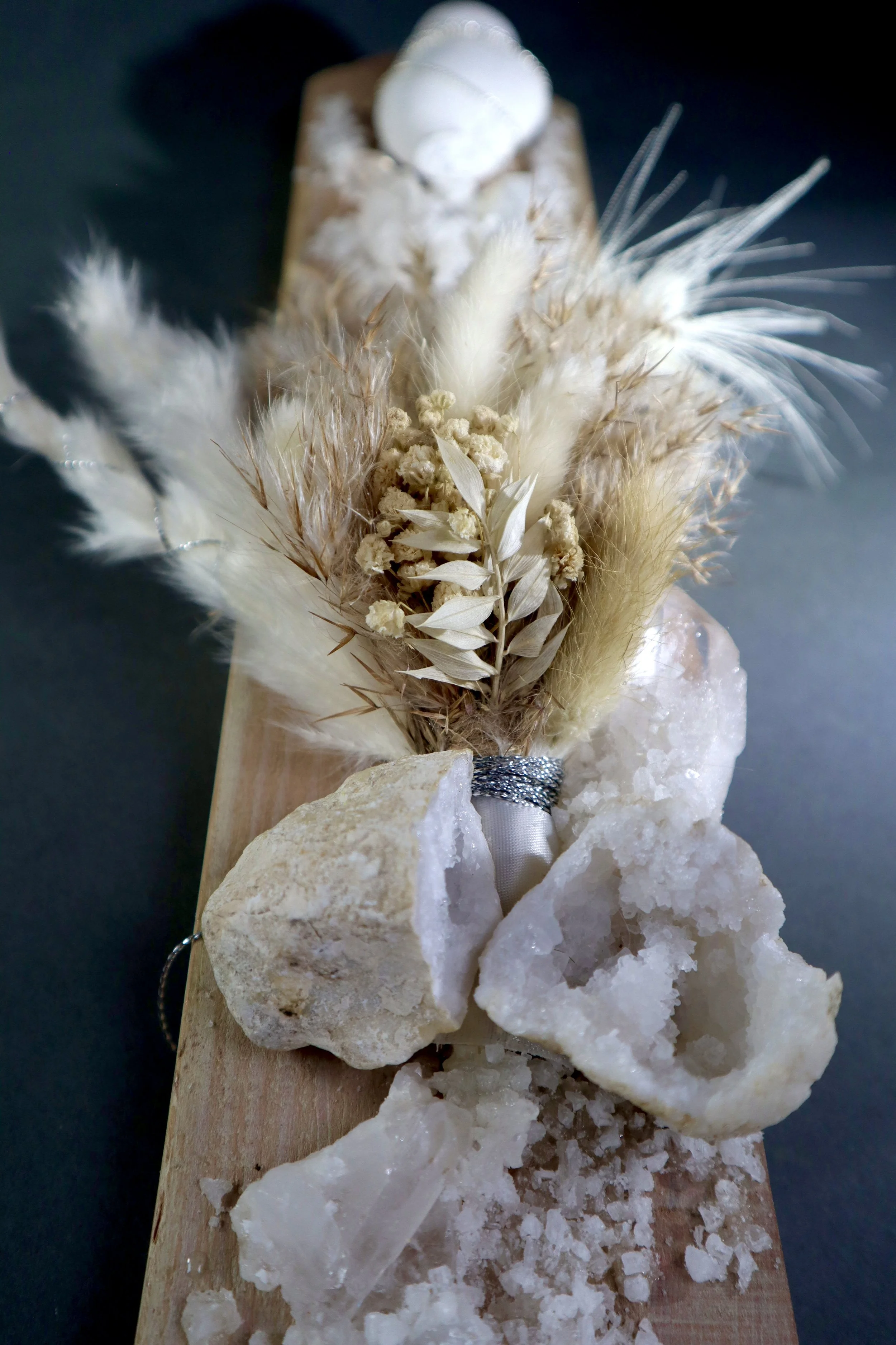 Minimalist mineral wall sculpture with white crystals, natural wood and layered botanical textures