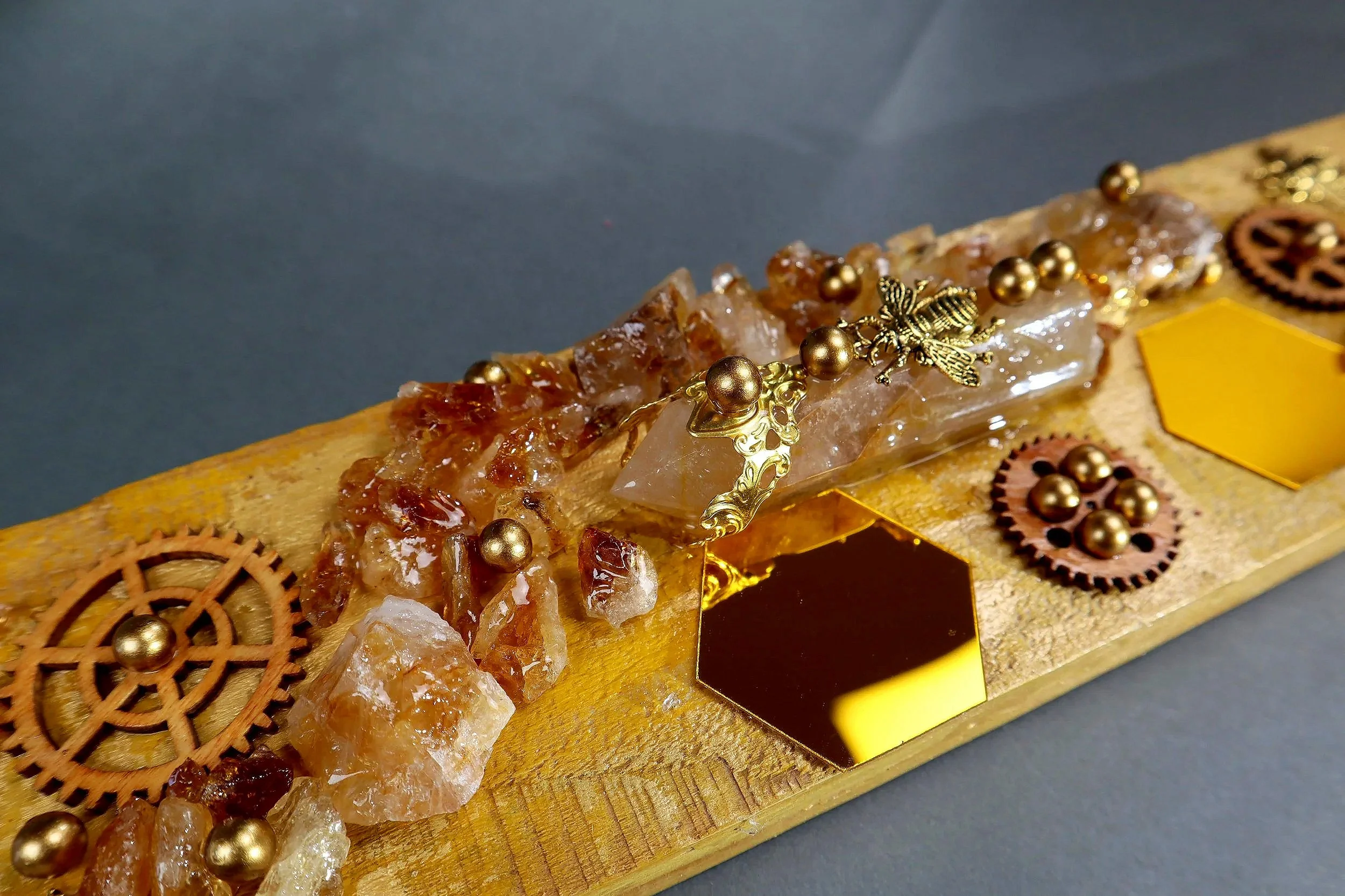 Citrine wall art with amber honeycomb shapes, gold crystal texture and sculptural details on wood