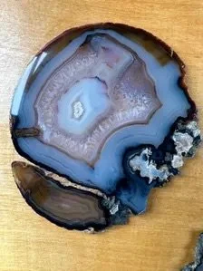 Close-up natural agate slice with grey black and translucent crystalline patterns for gemstone wall art