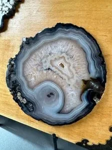 Two natural agate slices arranged on a square wood panel in a one of a kind mineral artwork