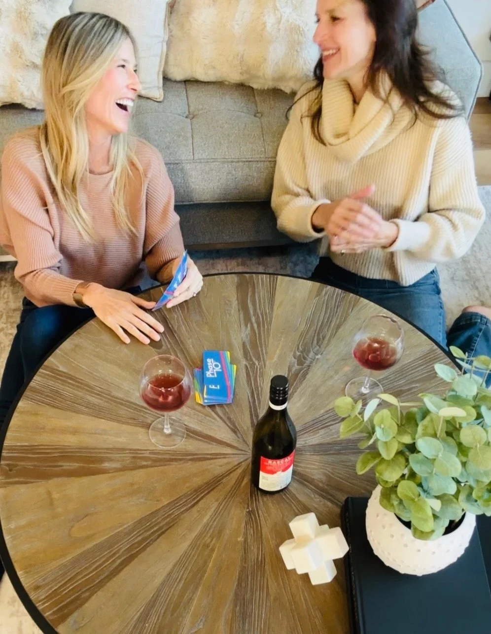 Tracy of A Curated Passport sharing laughter with a friend over a game night.