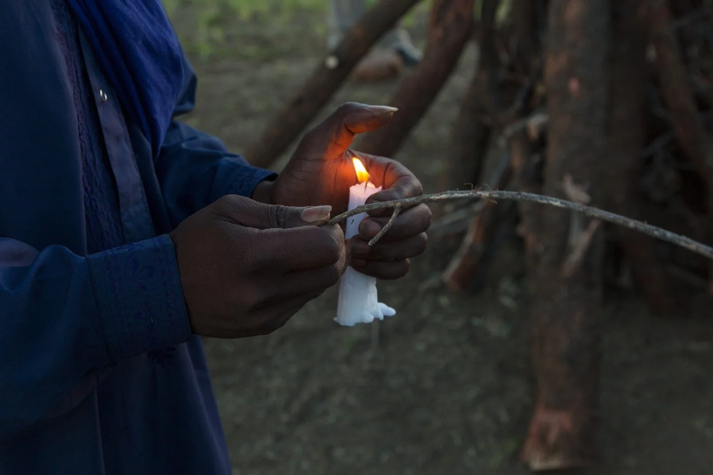 Ras Fireman lights the pyre to initiate the celebration.