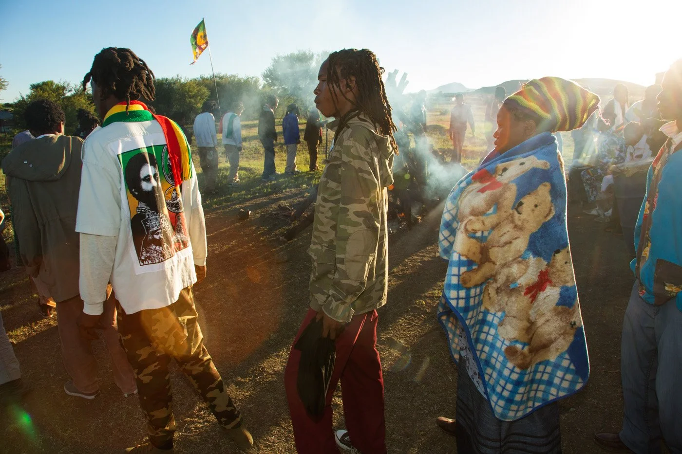 Brethren and sistren touring the Fire Key at sunrise. The community circles the fire in a continuous, chanting procession to purify and seal the sacred ground.
