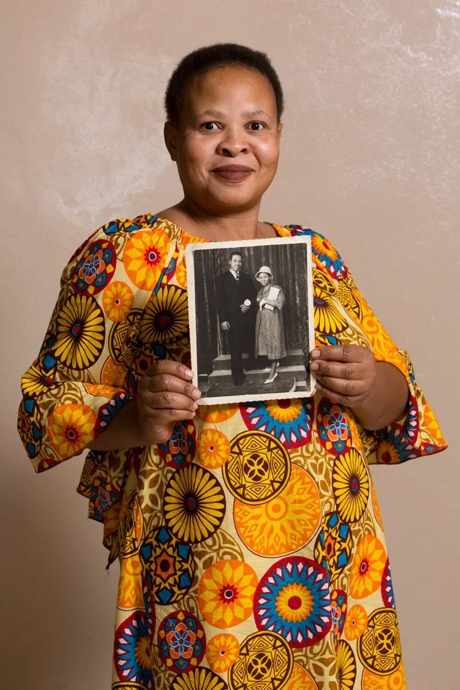 Mapheello 'Mapu' Agnes Qabalatsane (born Oct 17 1972) holds an analog black-and-white print of her parents' wedding portrait. Johannes Montsioa Qabalatsane and his wife Anastasia owned a grocery store and a bottle store in Kroonstad. Dad loved countr