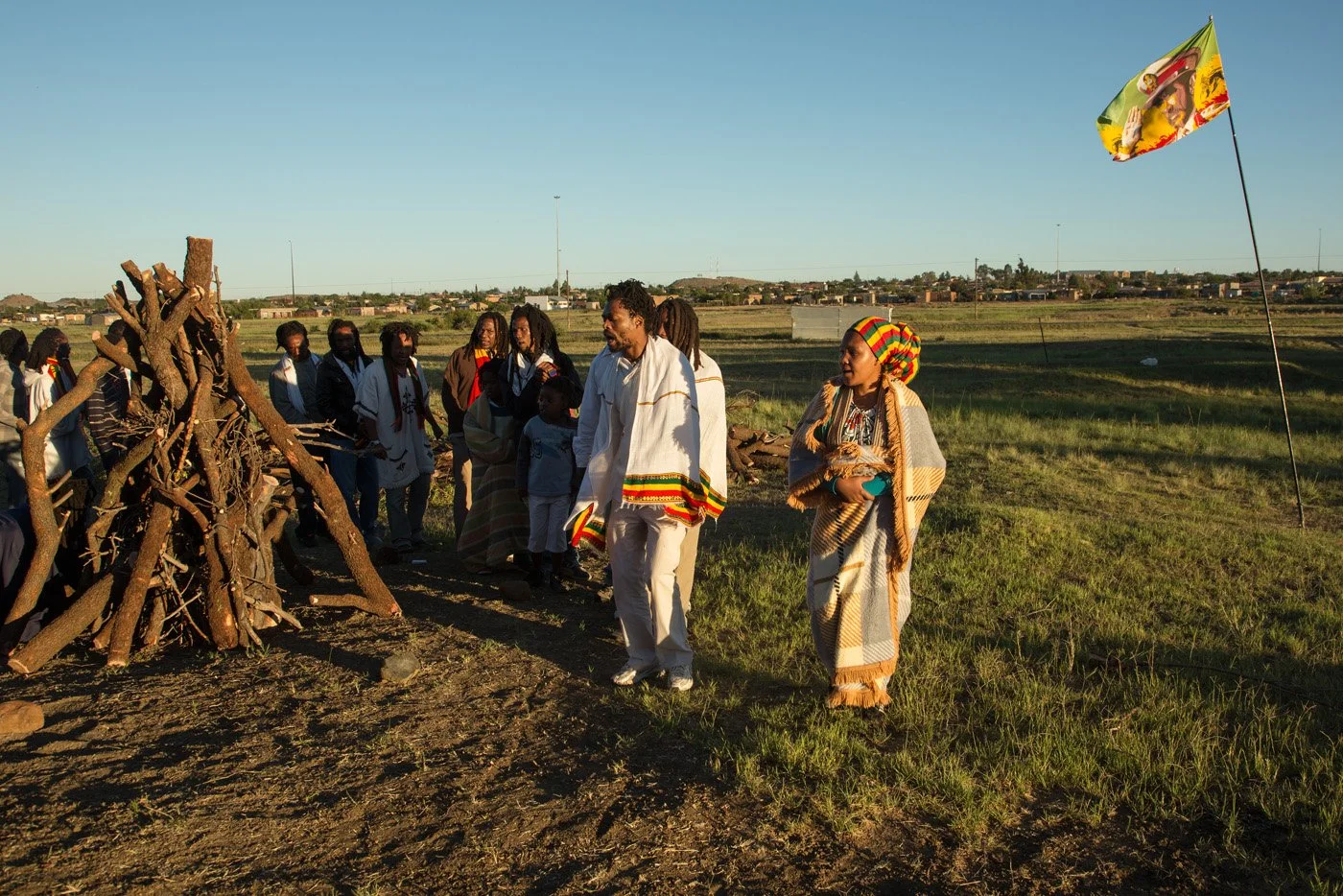 Brethren and sistren touring the Fire Key at sunrise. The community circles the fire in a continuous, chanting procession to purify and seal the sacred ground.