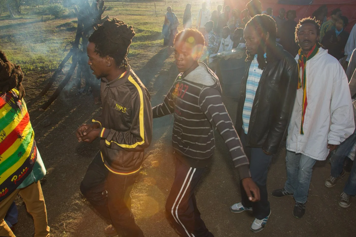 Brethren and sistren touring the Fire Key at sunrise. The community circles the fire in a continuous, chanting procession to purify and seal the sacred ground.