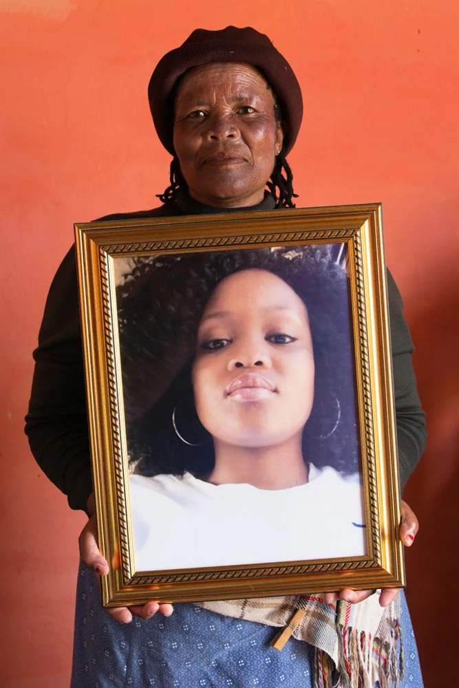 Hilda Sefuba, holding a framed colour photo of her late daughter Marriam. (Kamastone, Eastern Cape). 
