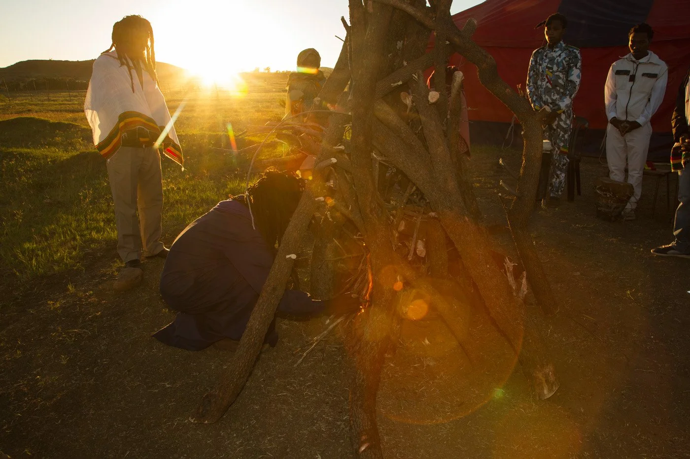 Ras Fireman lights the pyre to initiate the celebration.
