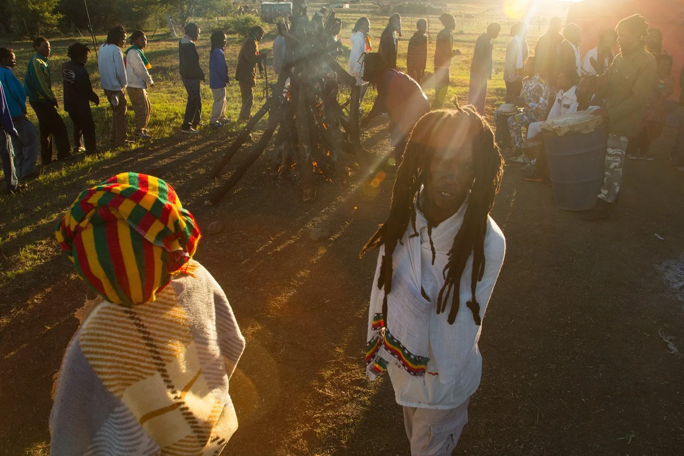 Brethren and sistren touring the Fire Key at sunrise. The community circles the fire in a continuous, chanting procession to purify and seal the sacred ground.