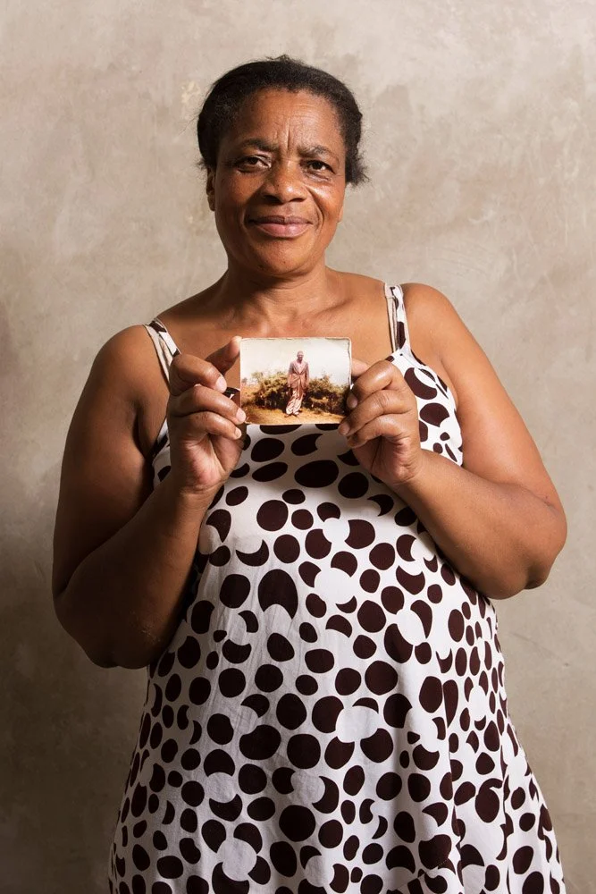 Kebogile Martha Khosholo holds a portrait of her grandfather, Seatlholo Simon Keme. Mr. Keme raised Martha and her two sisters on his farm in Thaba Nchu where he grew crops and raised cattle. She remembers that grandfather was strict but very loving 